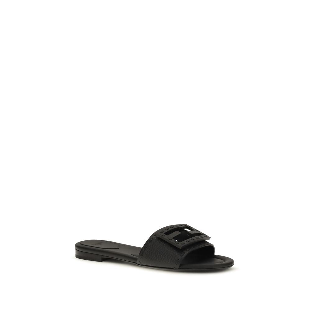 Elevate your style with Fendi's Black Calf Leather Bos Taurus Flat Sandals, a luxurious blend of exquisite craftsmanship and contemporary elegance for discerning tastes.