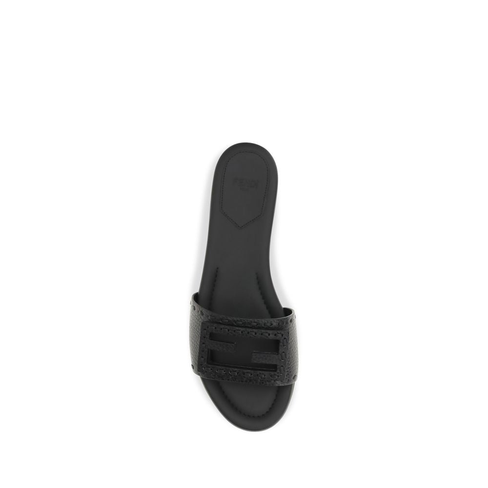 Experience the allure of Fendi's Black Calf Leather Bos Taurus Flat Sandals, where luxurious hammered calfskin meets exquisite craftsmanship for timeless elegance.