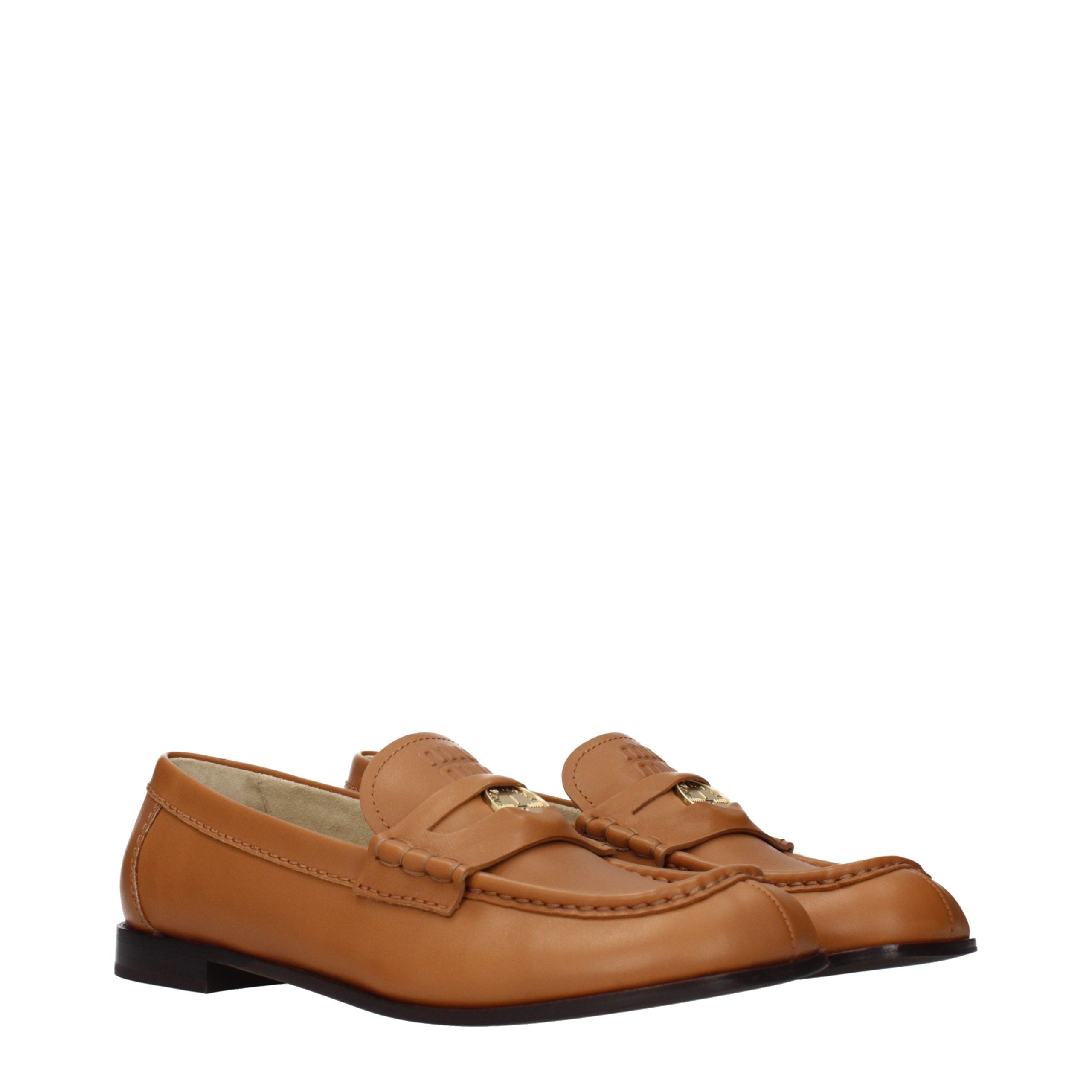 Elevate your elegance with Miu Miu's Brown Leather Slip-On Loafers, where exquisite craftsmanship meets timeless sophistication for the discerning individual.