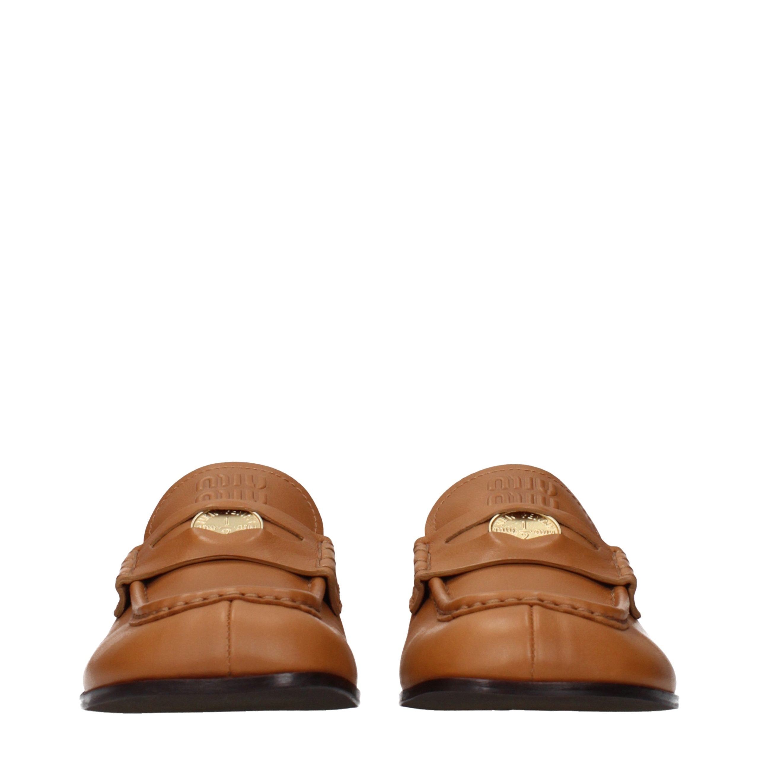 Indulge in Miu Miu's Brown Leather Slip-On Loafers, where exquisite craftsmanship meets timeless elegance, perfect for the discerning individual who embraces luxury.