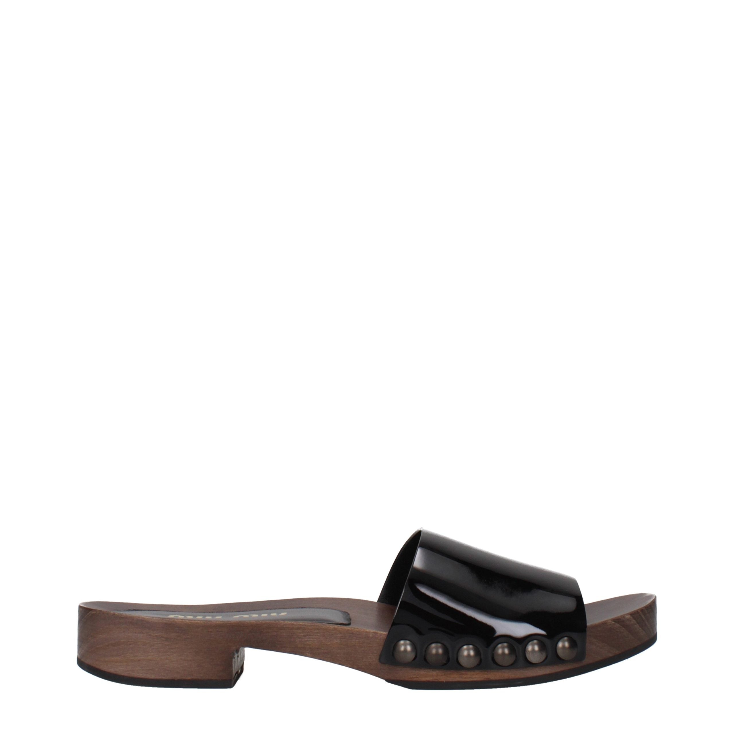 Discover the Miu Miu Black Leather Slippers, where exquisite patent leather meets timeless elegance, elevating your style with luxurious comfort for any occasion.