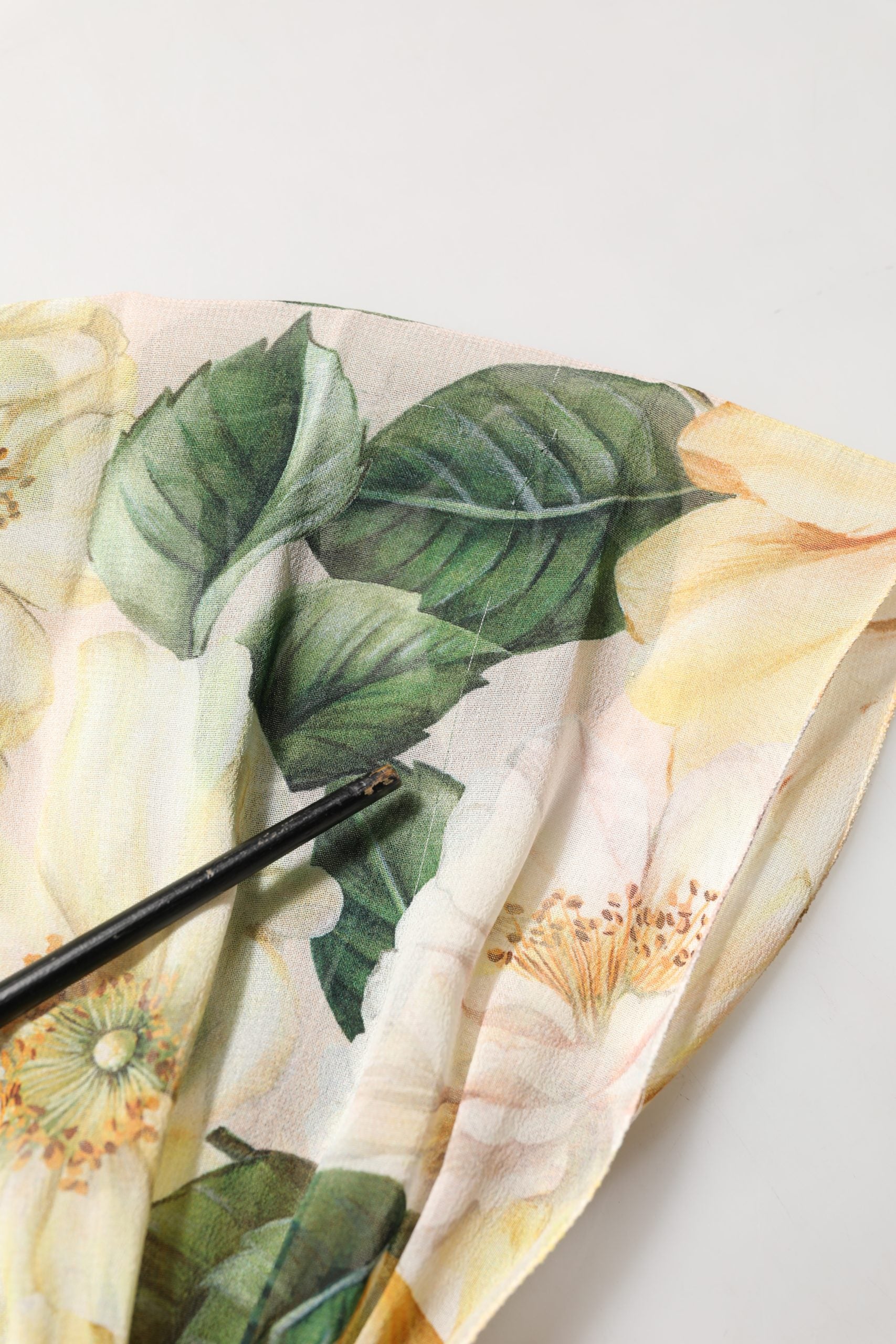 Indulge in the exquisite Dolce & Gabbana Yellow Floral Print Silk Pleated Maxi Dress, a masterpiece of Italian craftsmanship that embodies timeless elegance and sophistication.