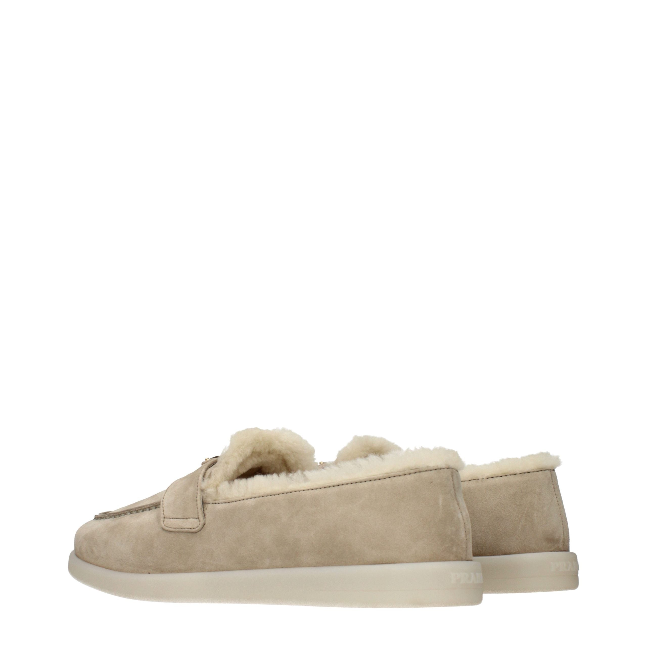 Experience the exquisite allure of Prada's Beige Leather Slip-On Loafers, where sumptuous suede meets unparalleled craftsmanship, embodying timeless elegance and sophistication.