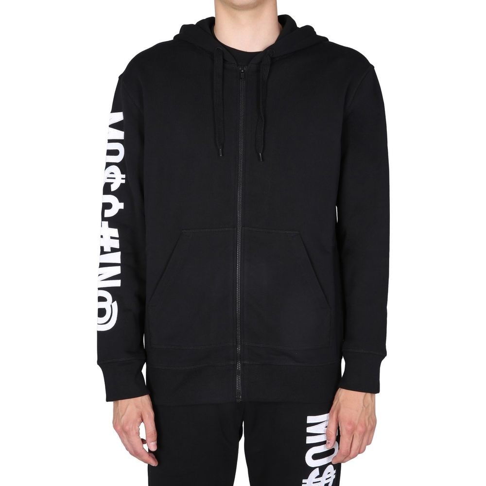 Indulge in the Moschino Couture Black Cotton Sweatshirt, a masterpiece of Italian craftsmanship, blending luxurious comfort with sophisticated style for the discerning individual.