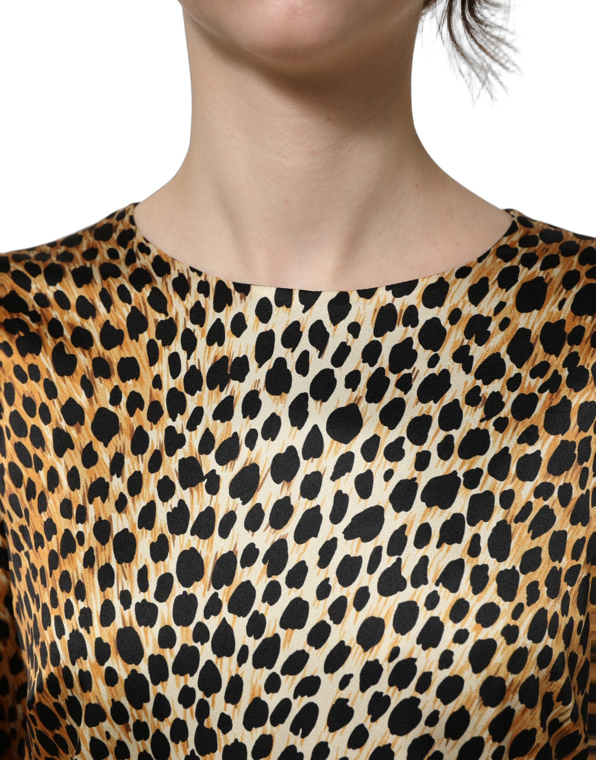 Experience the allure of the Dolce & Gabbana Brown Ocelot Print Long Sleeve Mini Dress, a luxurious blend of silk and elastane, embodying exquisite craftsmanship and timeless elegance.