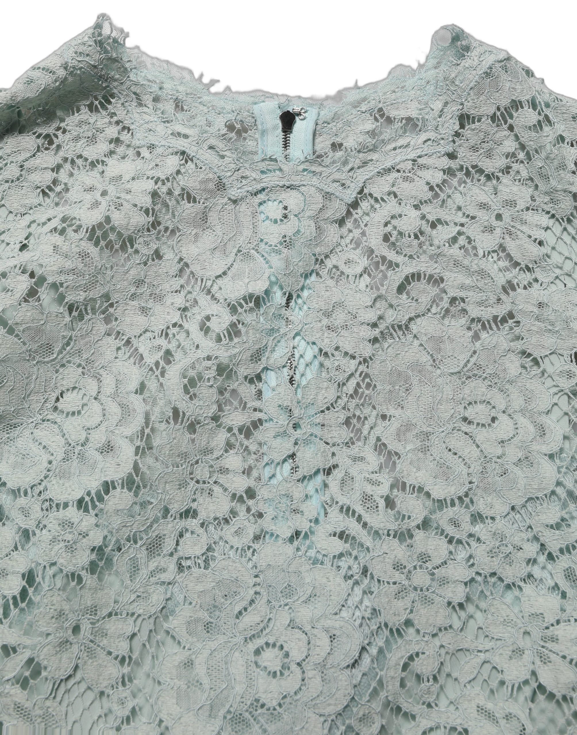 Experience the allure of Dolce & Gabbana's Mint Green Lace Sleeveless Dress, a masterpiece of floral lace and silk, embodying timeless elegance for unforgettable moments.