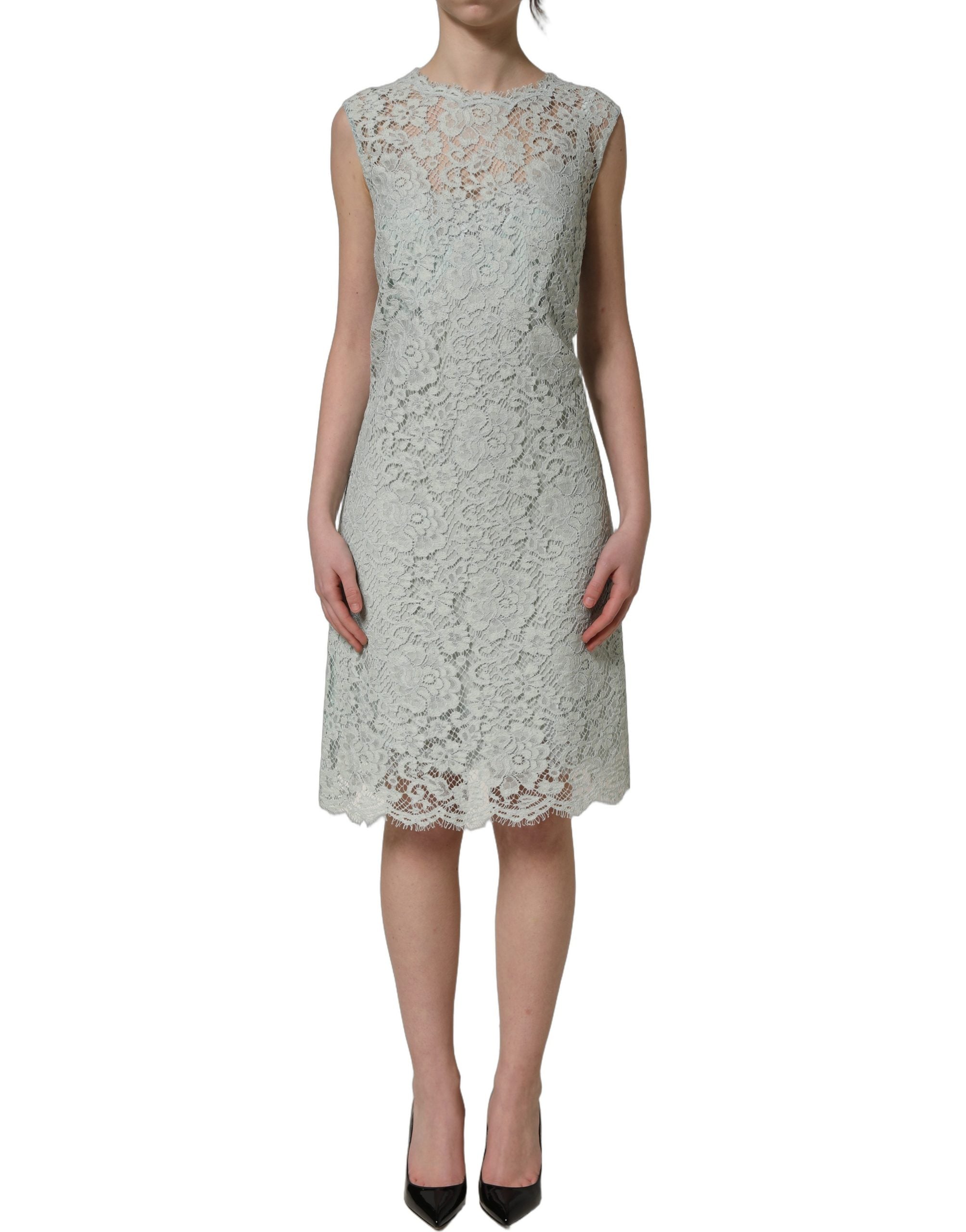 Experience the allure of the Dolce & Gabbana Mint Green Lace Sleeveless Dress, a masterpiece of floral lace and silk, epitomizing timeless elegance for the discerning individual.