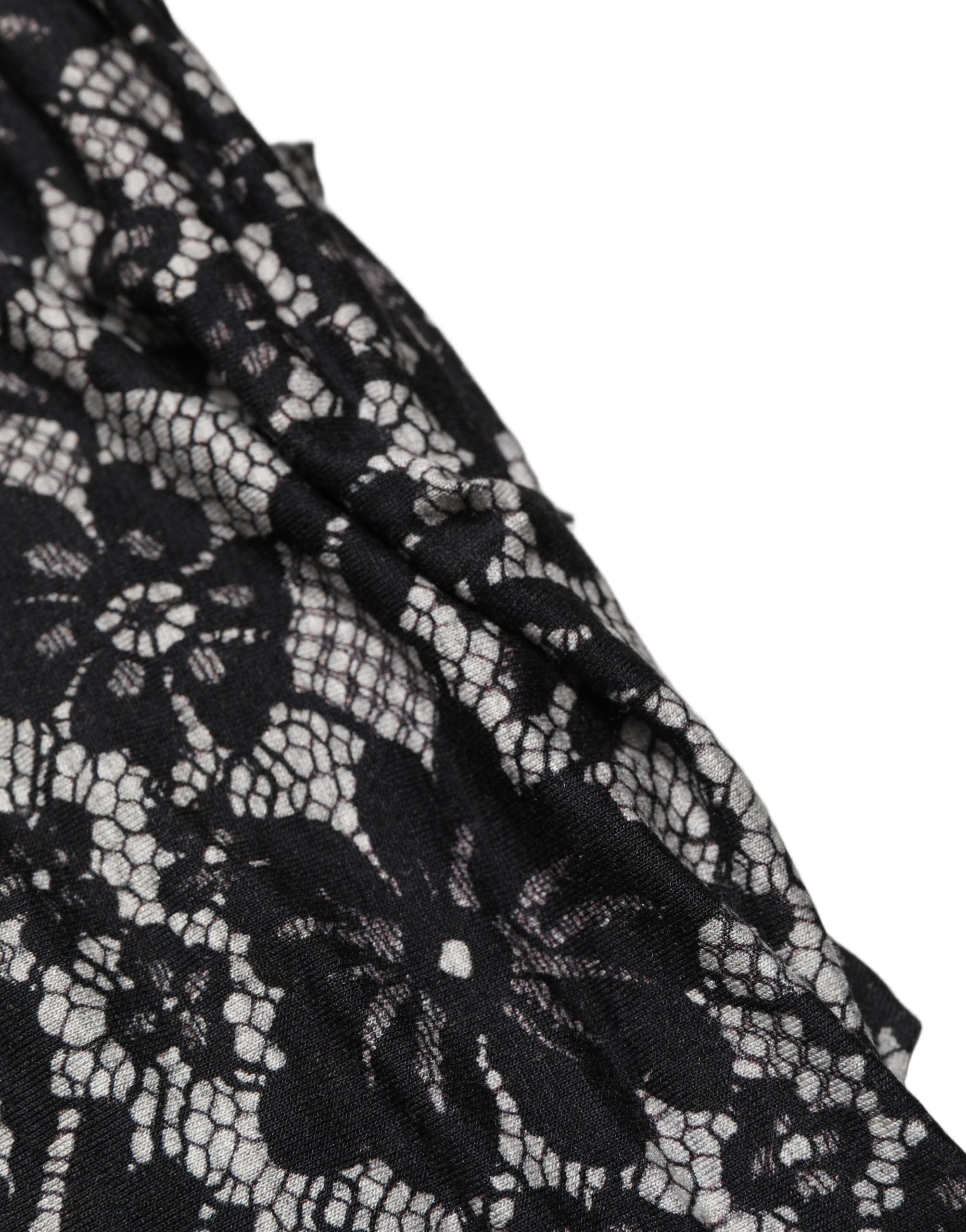Indulge in the exquisite Dolce & Gabbana Black White Floral Lace Sleeveless Midi Dress, a masterpiece of Italian craftsmanship that embodies timeless elegance and sophistication.