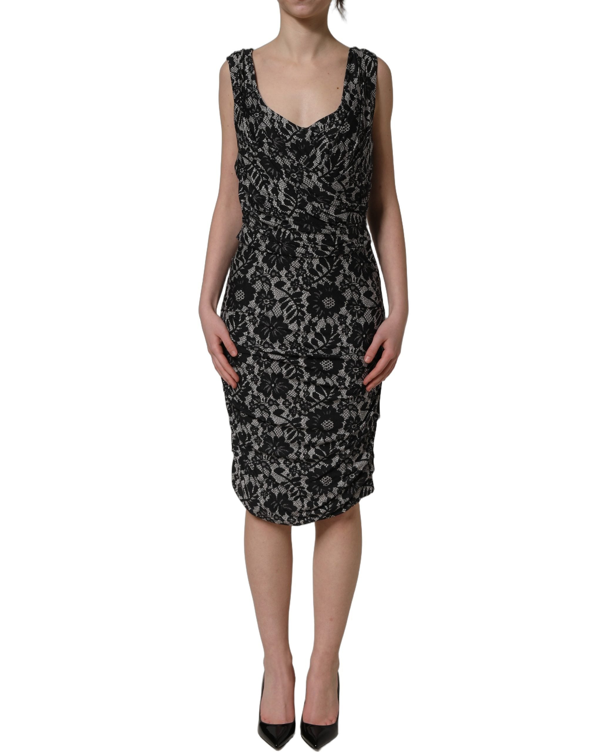 Elevate your elegance with the Dolce & Gabbana Black White Floral Lace Sleeveless Midi Dress, a masterpiece of Italian craftsmanship that embodies timeless sophistication.