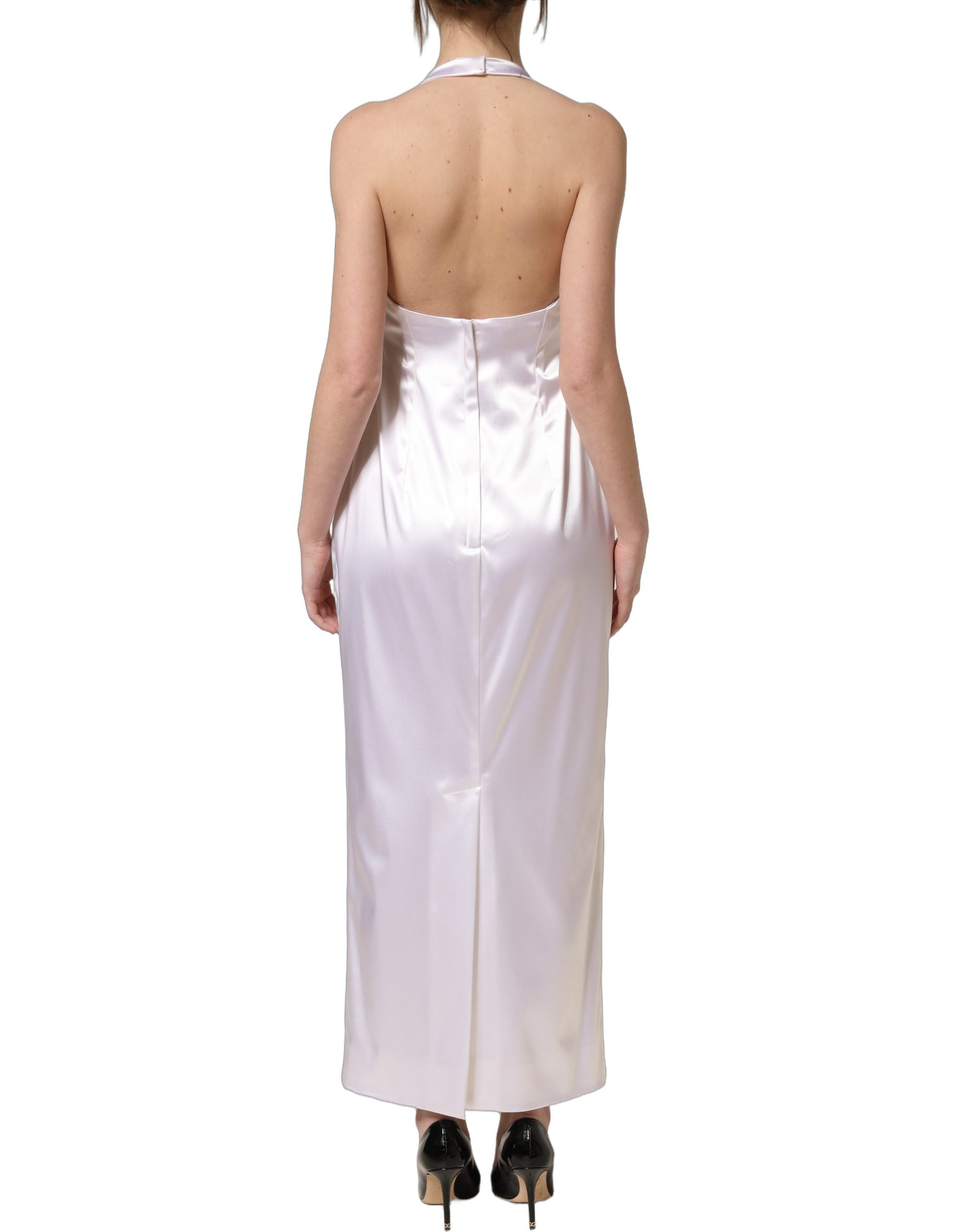 Experience the allure of the Dolce & Gabbana White Satin Halter Backless Long Gown, a masterpiece of Italian craftsmanship that embodies timeless elegance and sophistication.