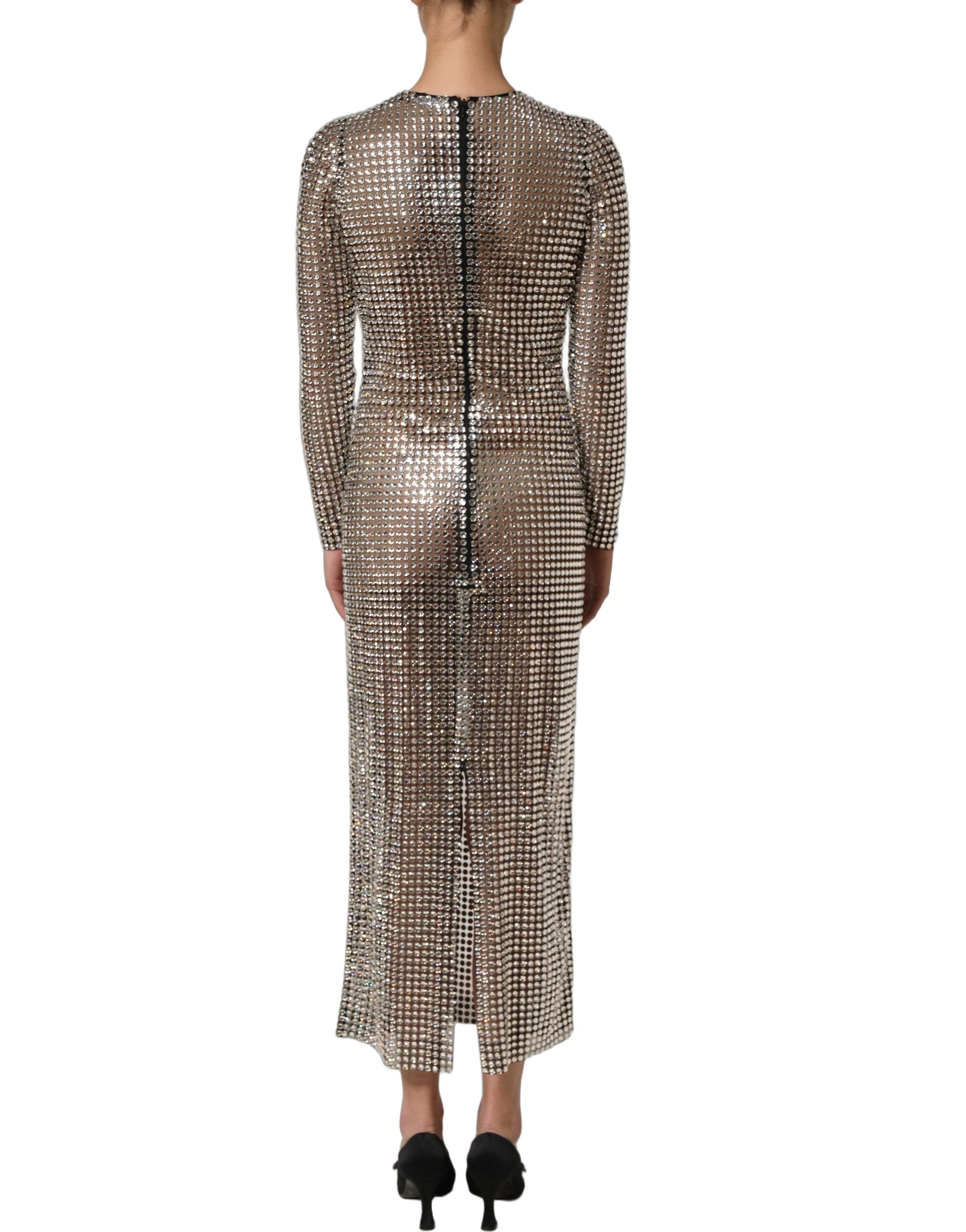 Experience the allure of the Dolce & Gabbana Beige Crystal Embellished Long Gown, a masterpiece in exquisite craftsmanship that redefines luxury for the discerning individual.
