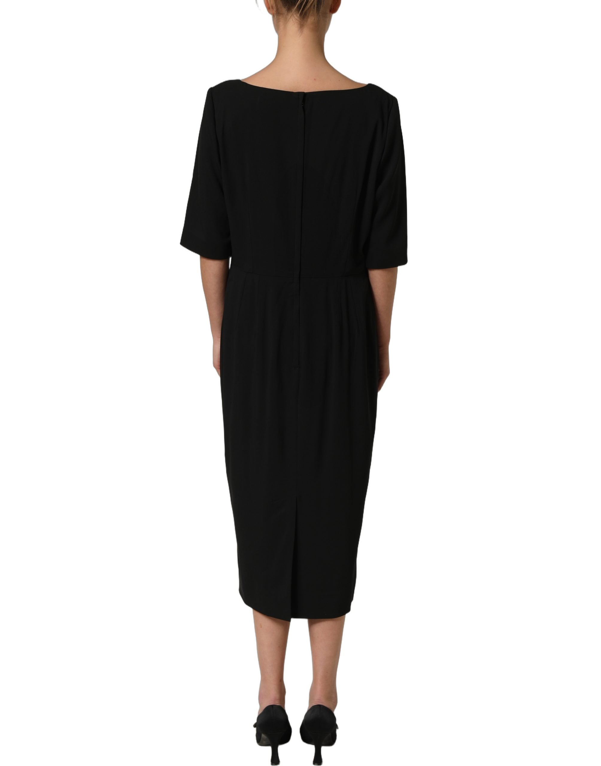 Indulge in the exquisite allure of the Dolce & Gabbana Black Viscose Cropped Sleeves Midi Dress, where luxurious craftsmanship meets timeless elegance for the discerning individual.