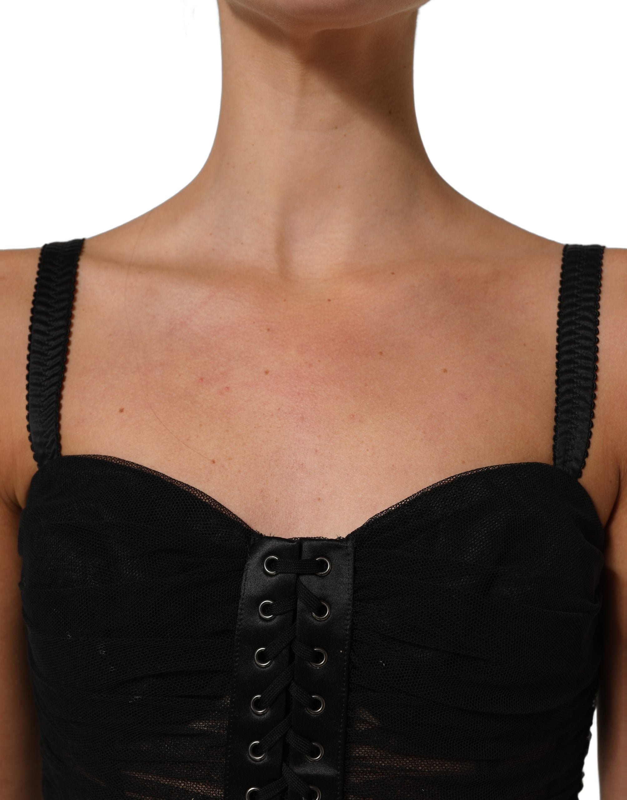 Indulge in the allure of Dolce & Gabbana's exquisite black sleeveless dress, a masterpiece of Italian craftsmanship that embodies timeless elegance and sensual sophistication.