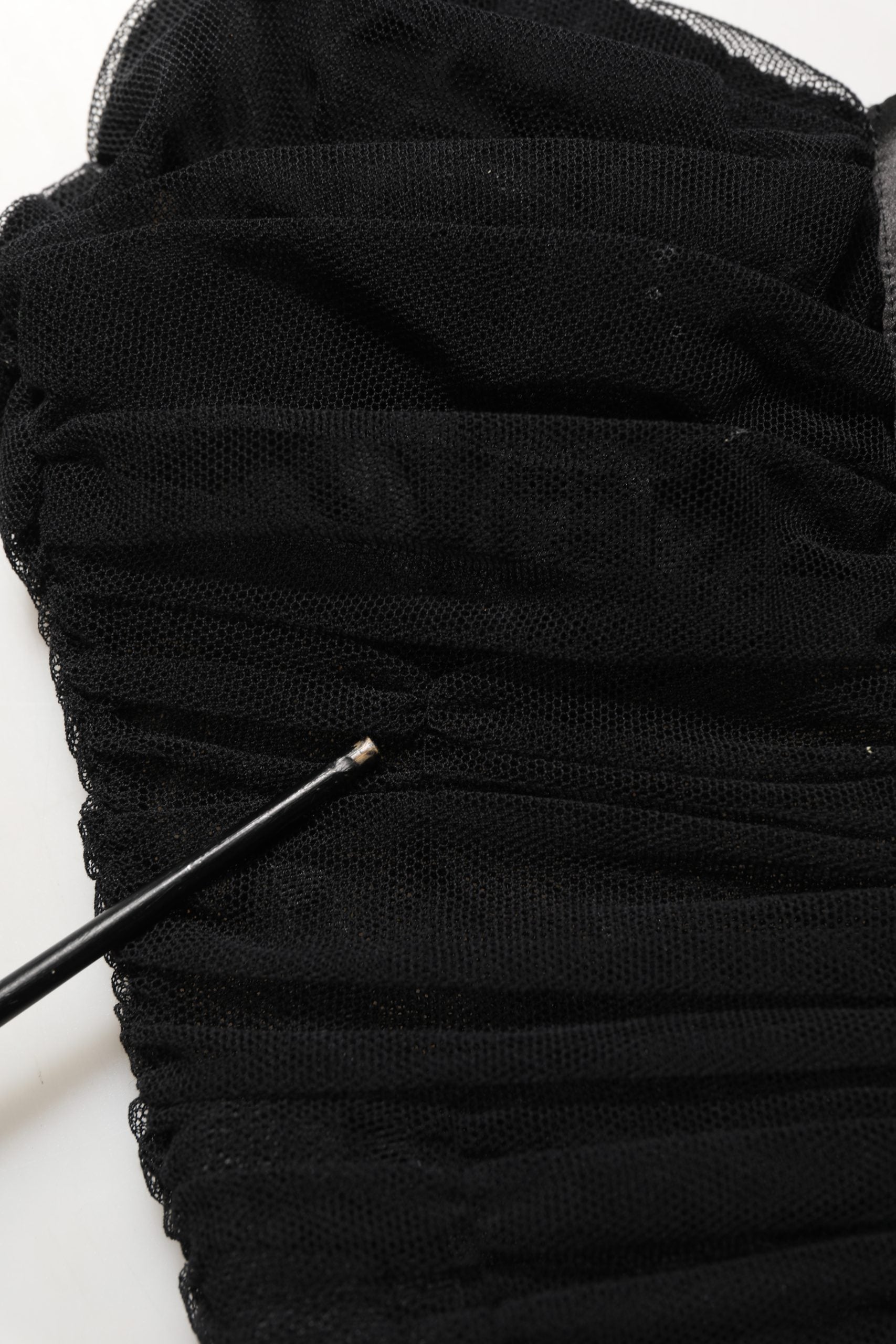 Indulge in the allure of Dolce & Gabbana's exquisite black sleeveless dress, a testament to Italian craftsmanship, perfect for unforgettable soirées.