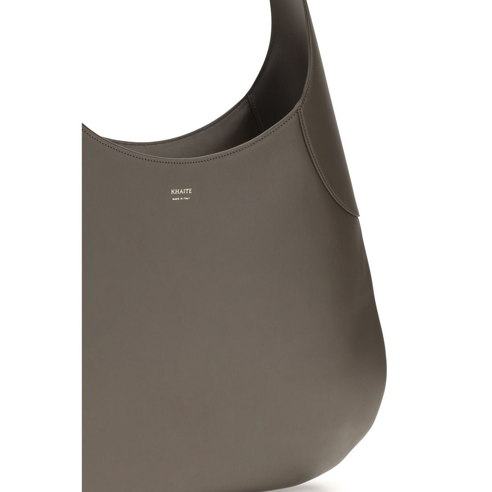 Experience the Khaite Gray Calf Leather Bos Taurus Handbag, a masterpiece of artisanal elegance, blending luxurious craftsmanship with timeless sophistication for the discerning individual.