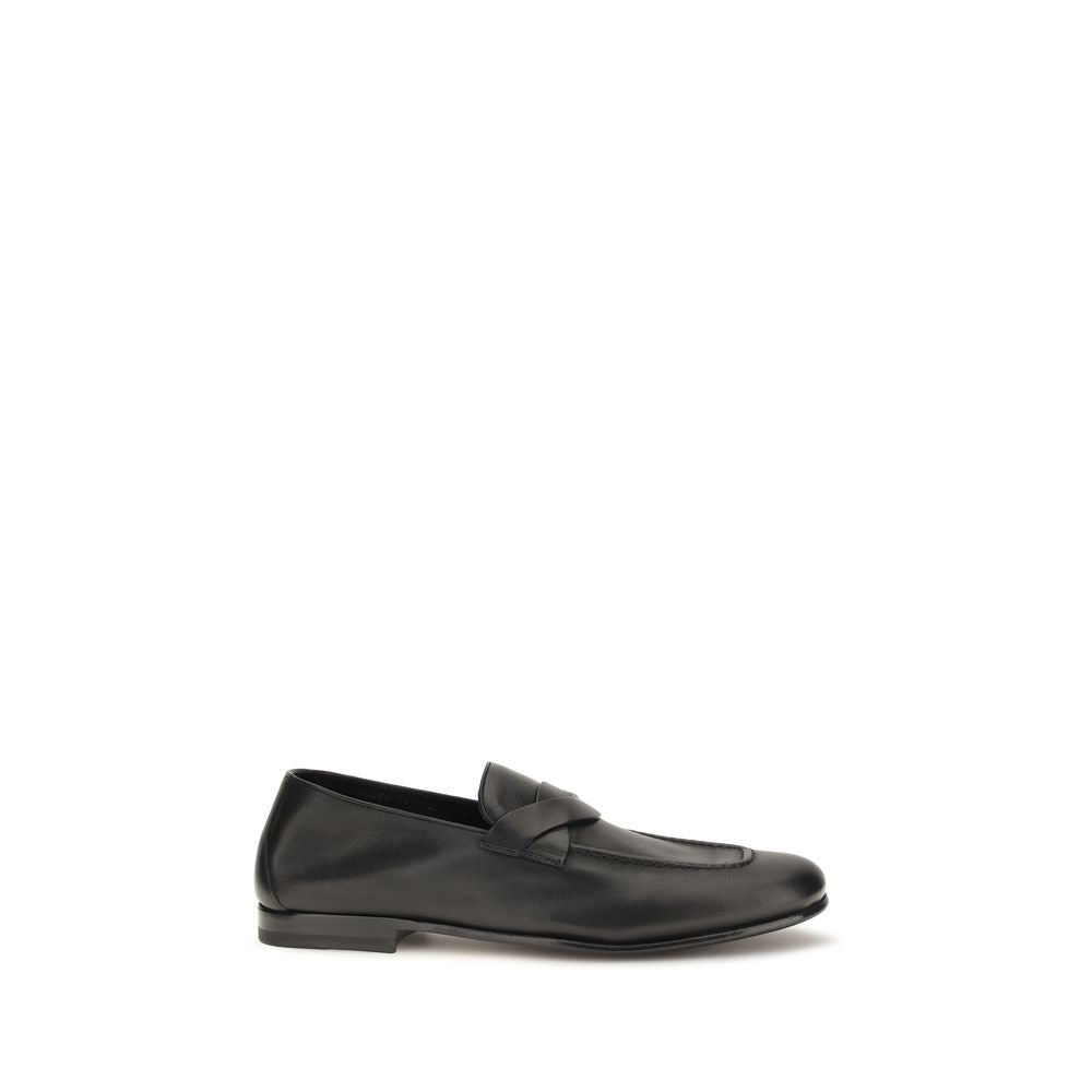 Elevate your style with Tom Ford's Black Calf Leather Bos Taurus Slip-On Loafers, a masterpiece of artisanal elegance that embodies luxury and sophistication.