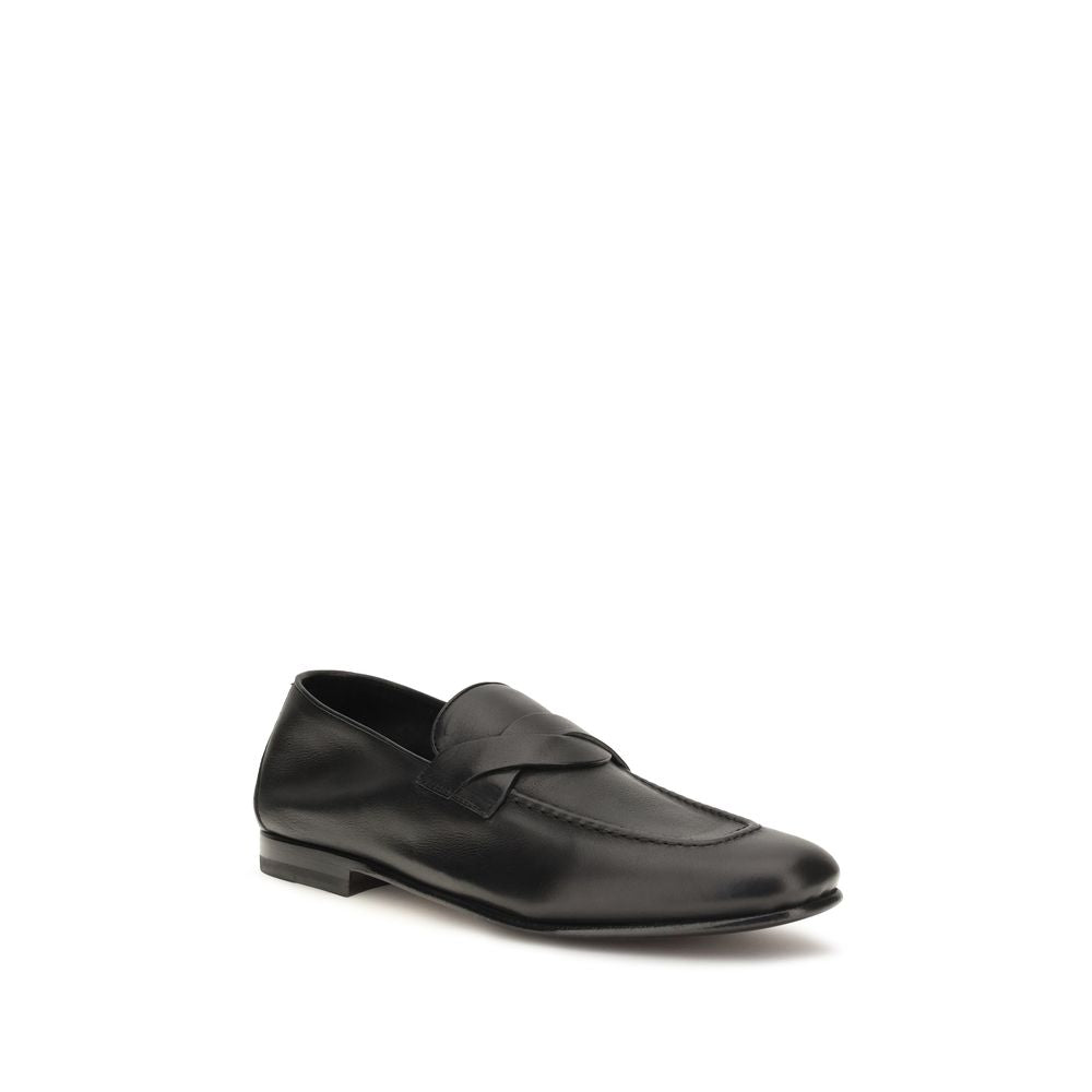 Elevate your style with Tom Ford's Black Calf Leather Bos Taurus Slip-On Loafers, where artisanal craftsmanship meets timeless elegance for the discerning individual.