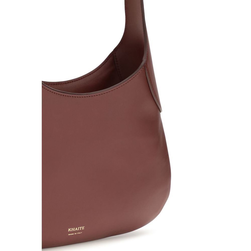 Indulge in the Khaite Bordeaux Calf Leather Bos Taurus Handbag, a symbol of artisanal elegance, crafted for the discerning individual who appreciates refined luxury.