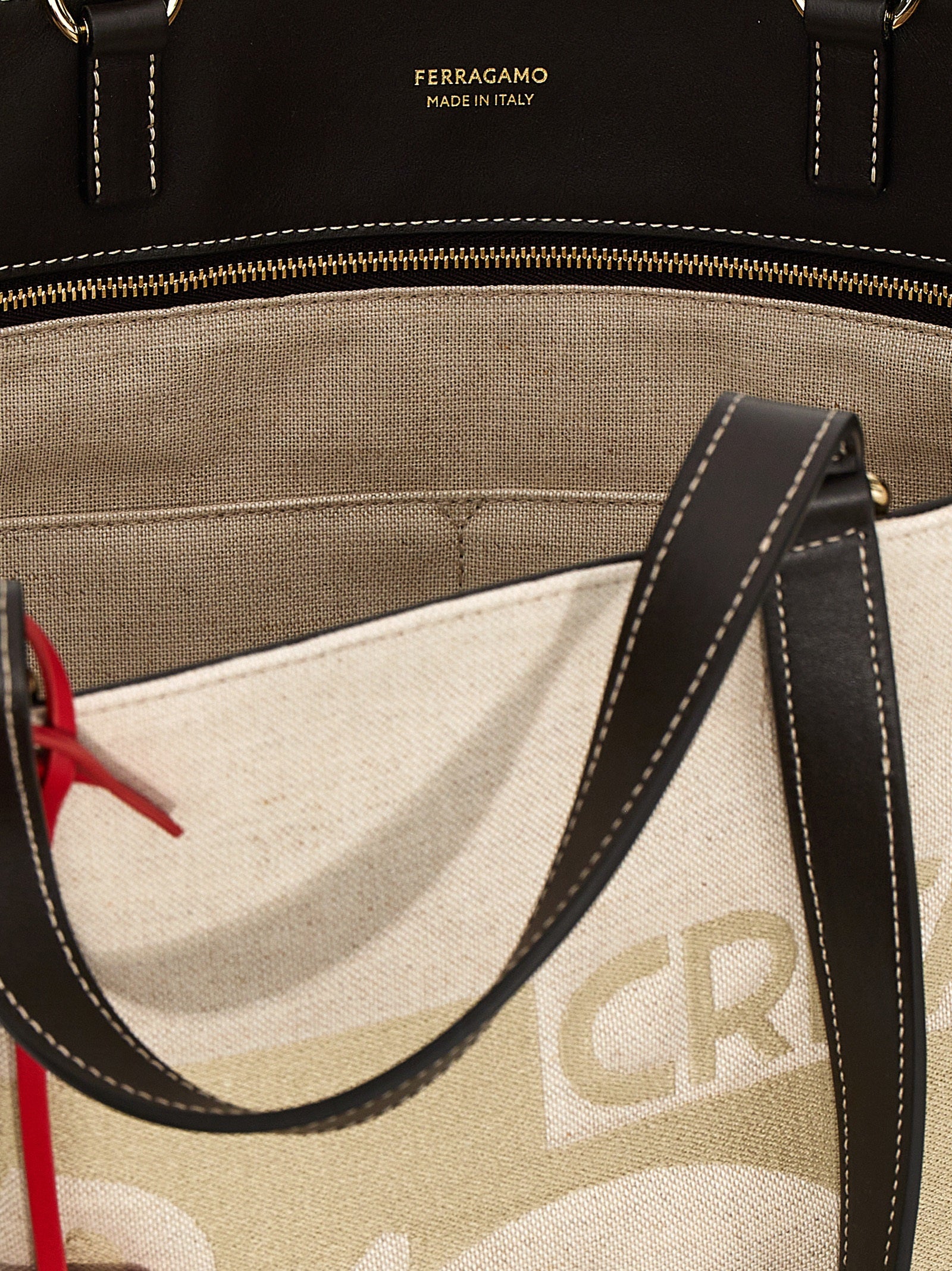 Experience the allure of the Ferragamo Beige Fabric Tote Bag, a masterpiece of Italian craftsmanship that embodies timeless elegance and sophisticated luxury for the discerning individual.