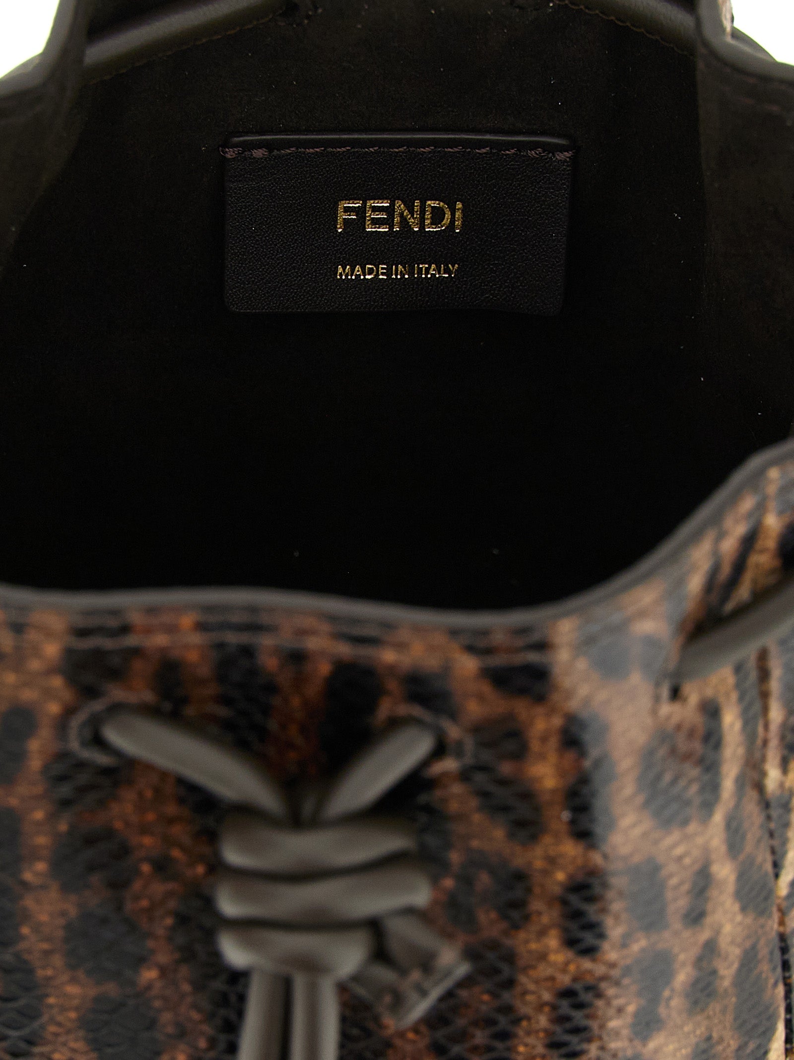Discover the Fendi Mon Tresor mini bucket bag, a luxurious blend of artisanal craftsmanship and exquisite karung snake leather, perfect for elevating any ensemble.