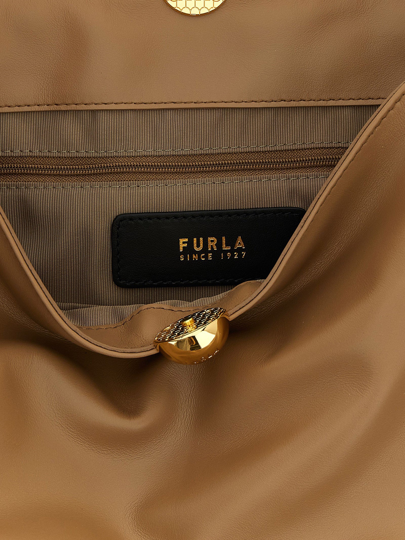 Indulge in the Furla Beige Calfskin Shoulder Bag, a masterpiece of Italian craftsmanship that embodies timeless elegance and sophisticated allure for the discerning trendsetter.
