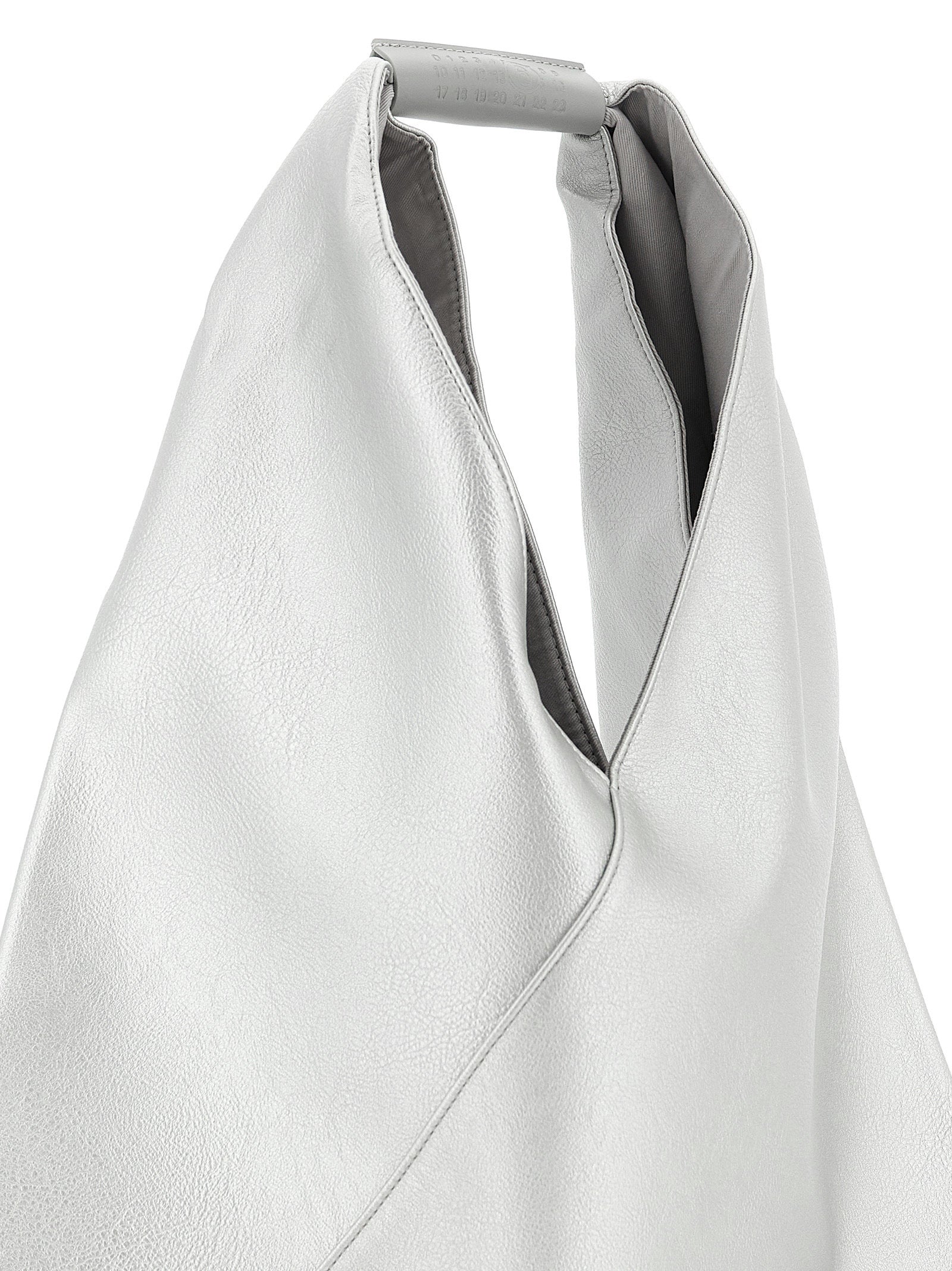 Discover the MM6 Maison Margiela Silver Handbag, a luxurious blend of avant-garde design and exceptional craftsmanship, perfect for the discerning trendsetter.