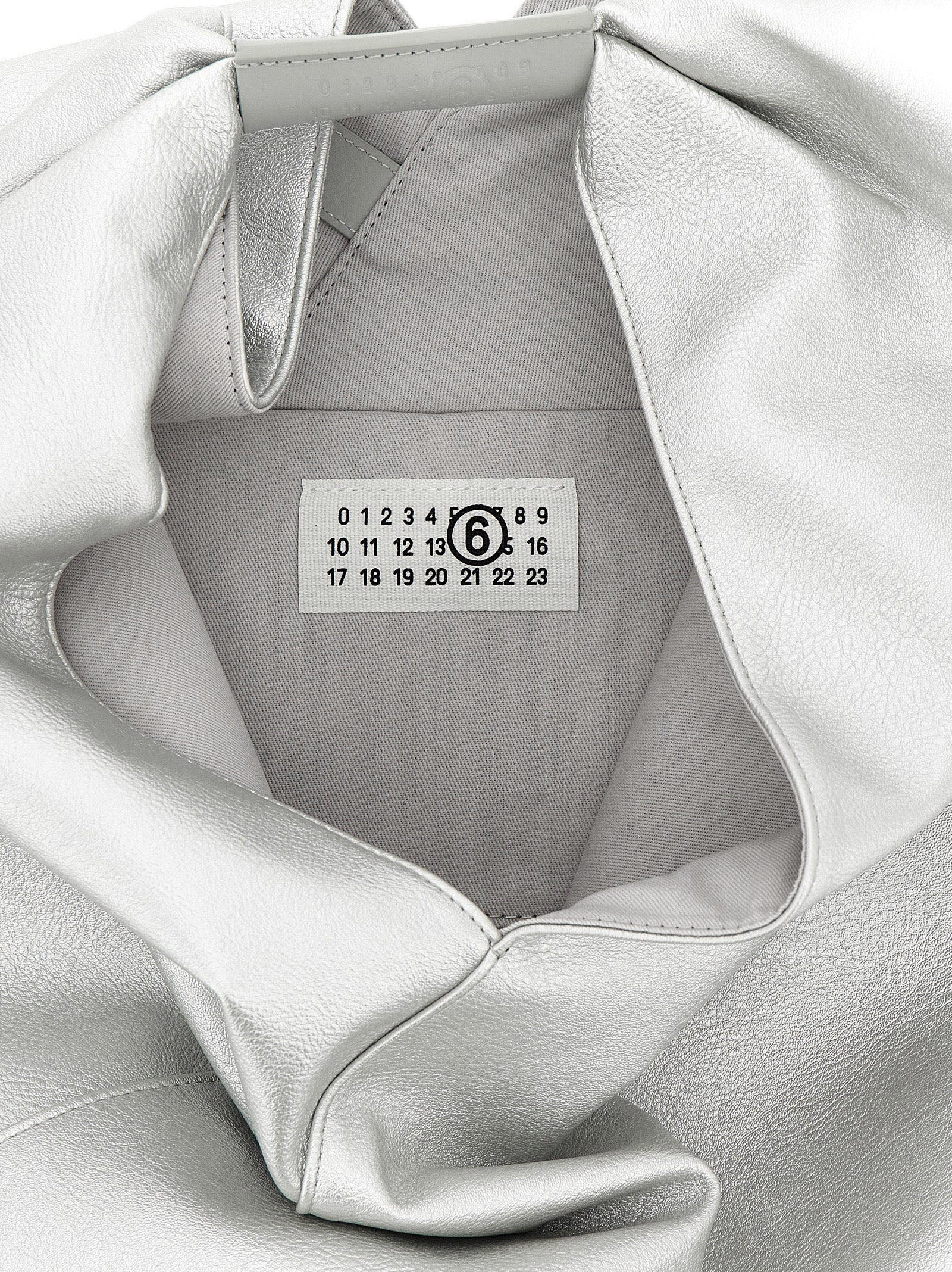 Discover the MM6 Maison Margiela Silver Handbag, a luxurious fusion of avant-garde design and exceptional craftsmanship, perfect for the discerning trendsetter.