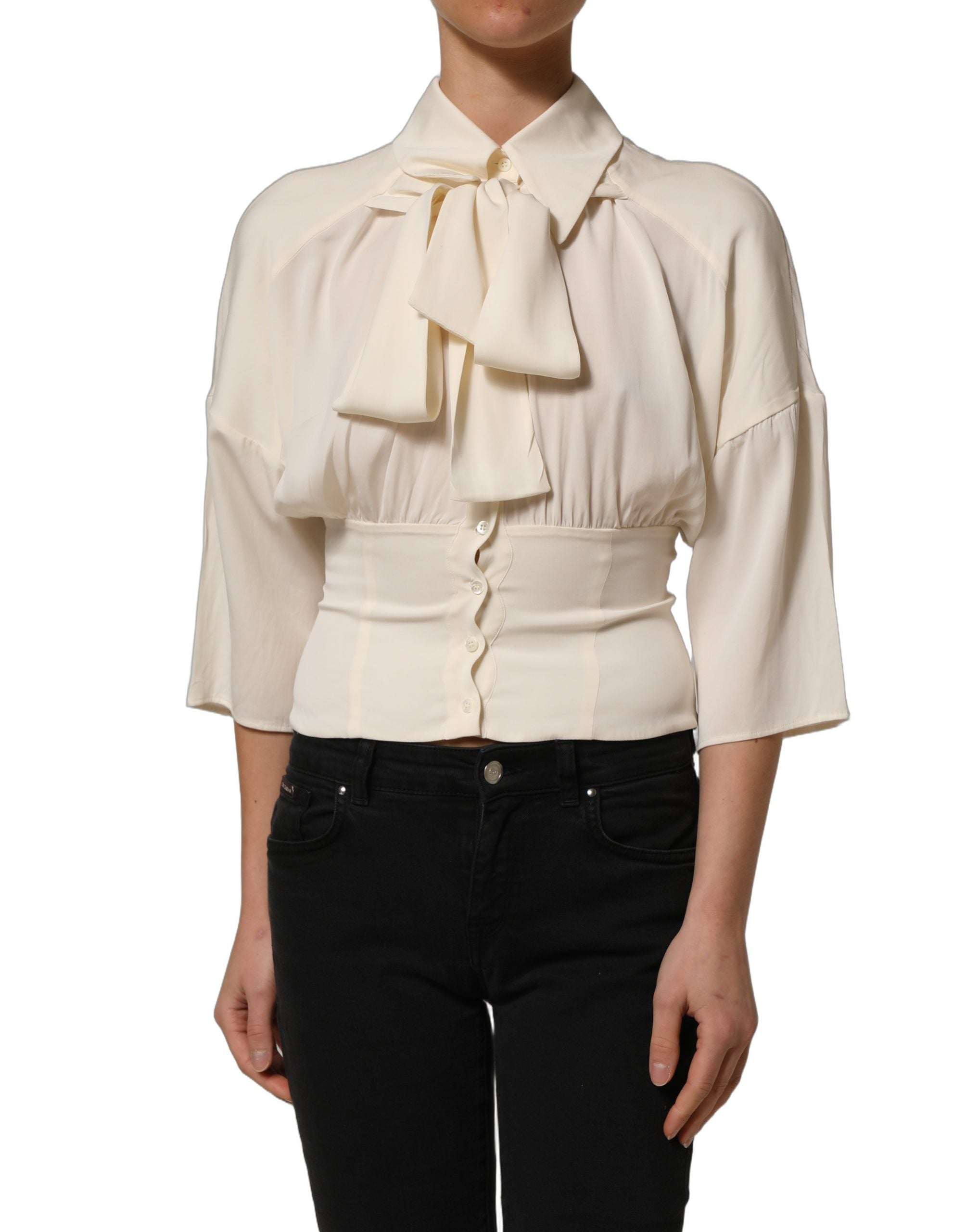 Discover the Dolce & Gabbana Off White Ascot Collar Blouse, a silk blend masterpiece that embodies timeless elegance and Italian craftsmanship for the discerning individual.