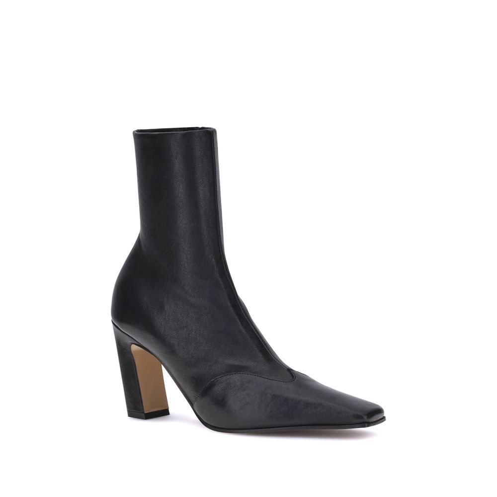 Elevate your style with Khaite's Black Calf Leather Bos Taurus Ankle Boots, a fusion of bold design and artisanal luxury for the modern connoisseur.