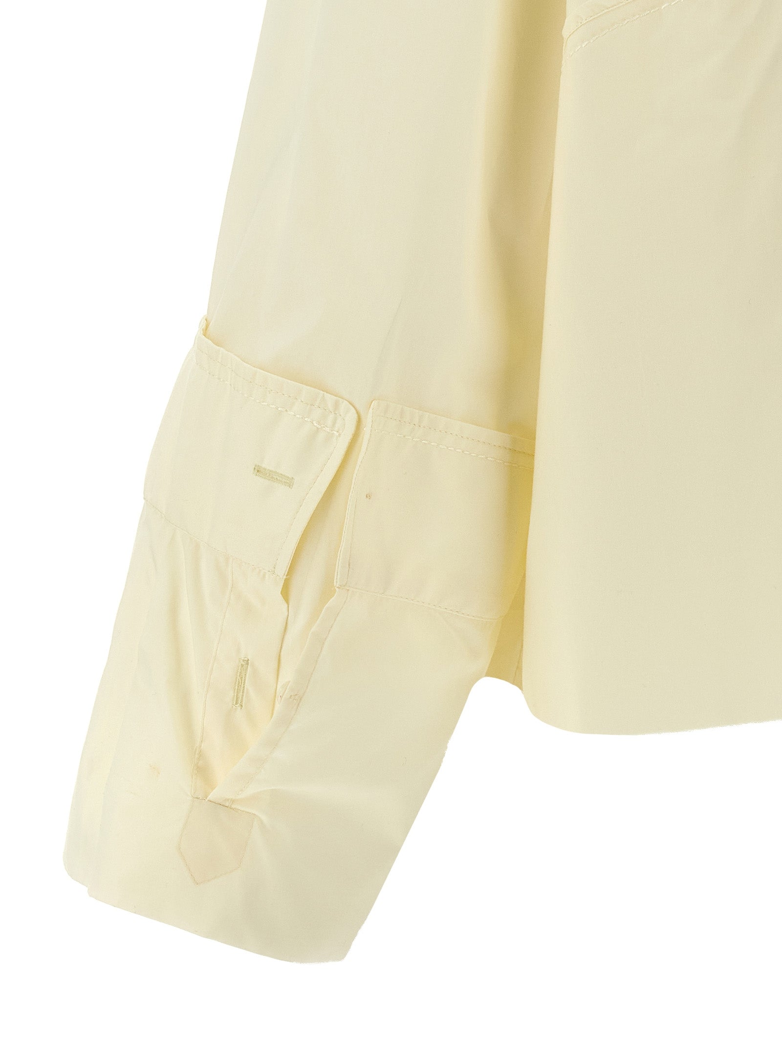 Elevate your style with the MM6 Maison Margiela White Cotton Blouse, a luxurious blend of avant-garde design and exquisite craftsmanship, perfect for any occasion.
