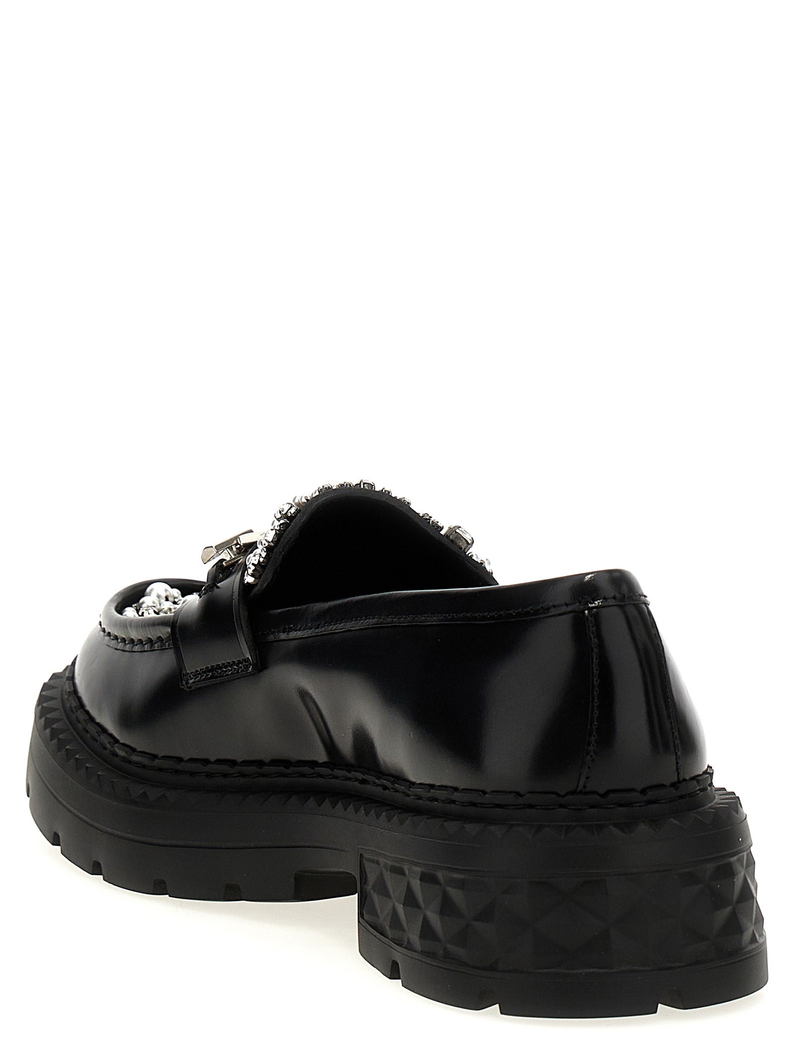 Step into the realm of elegance with Jimmy Choo's Black Calfskin Slip-On Loafers, where exquisite craftsmanship and luxurious materials redefine sophistication for the discerning individual.