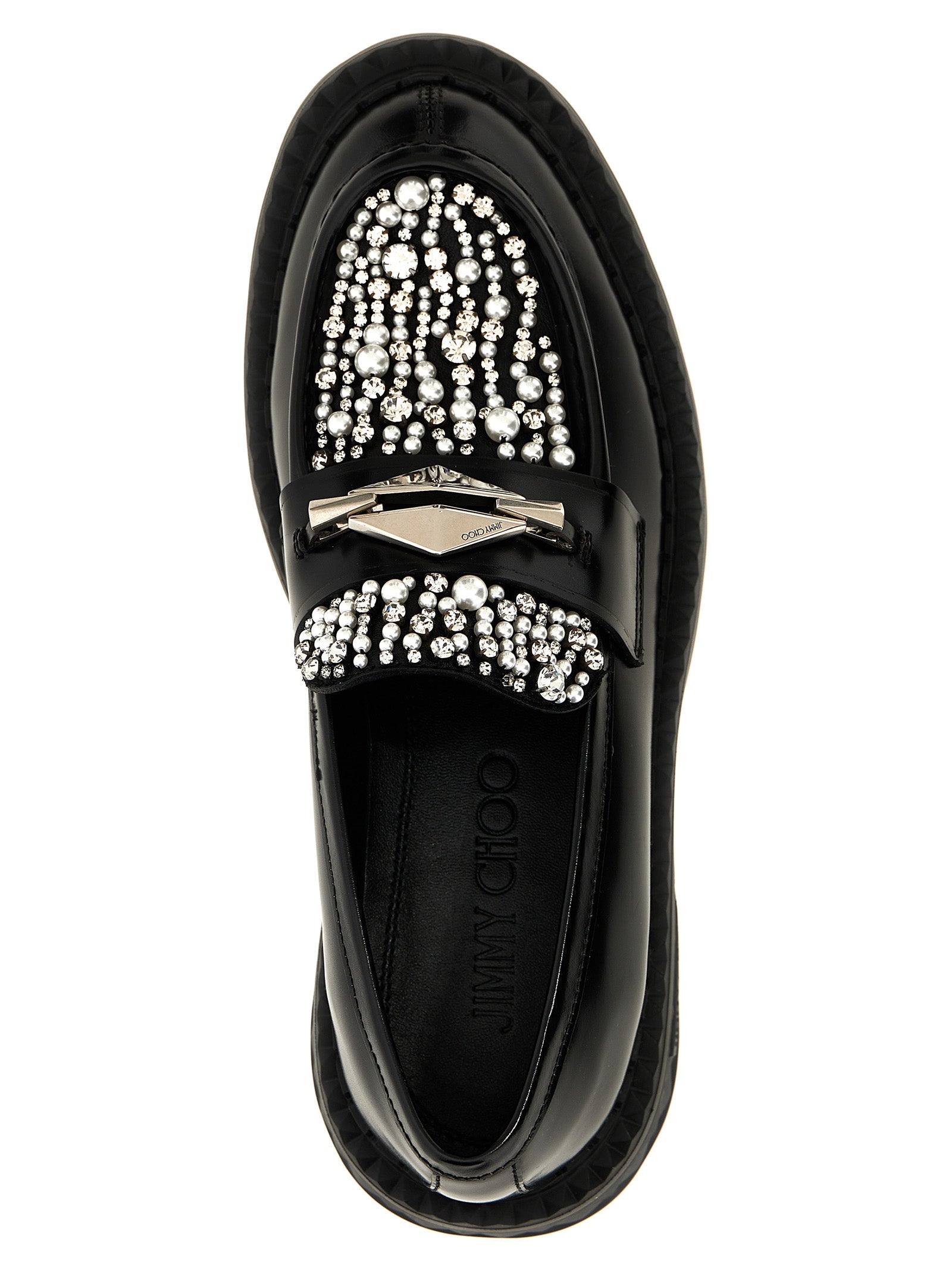 Elevate your style with Jimmy Choo's Black Calfskin Slip-On Loafers, a masterpiece of Italian craftsmanship blending luxury and allure for the discerning individual.