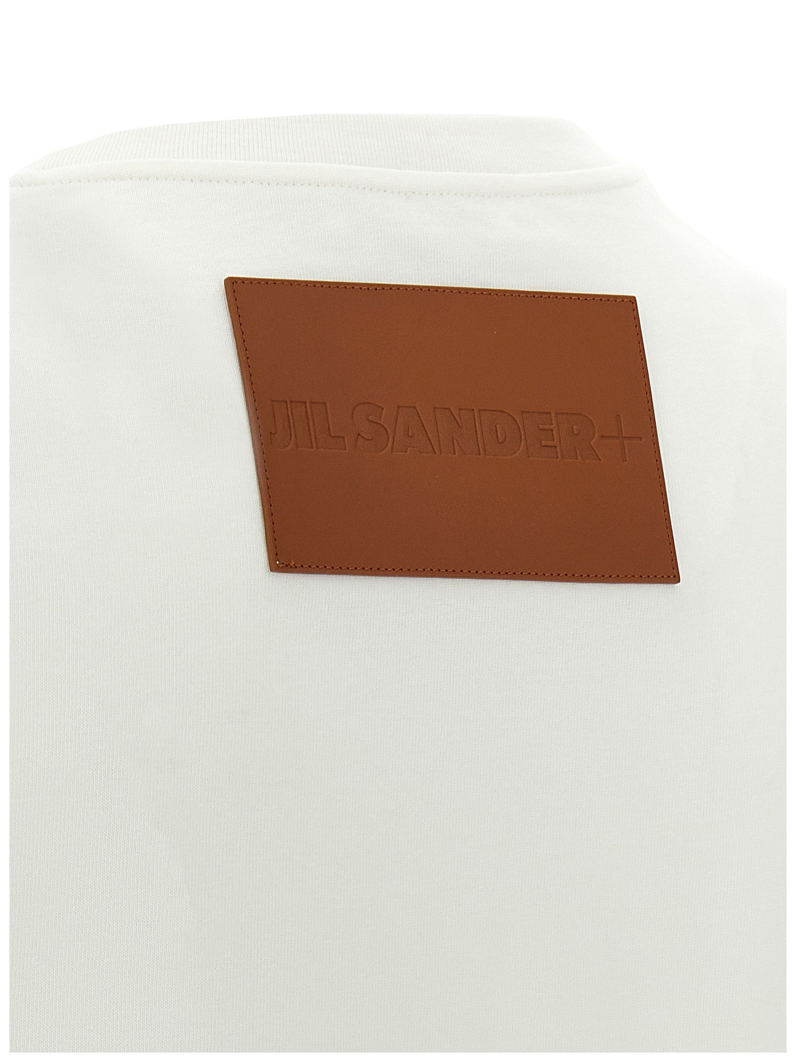 Elevate your style with Jil Sander's White Cotton T-Shirt, a masterpiece of Italian craftsmanship, featuring a bold leather logo for timeless luxury and sophistication.