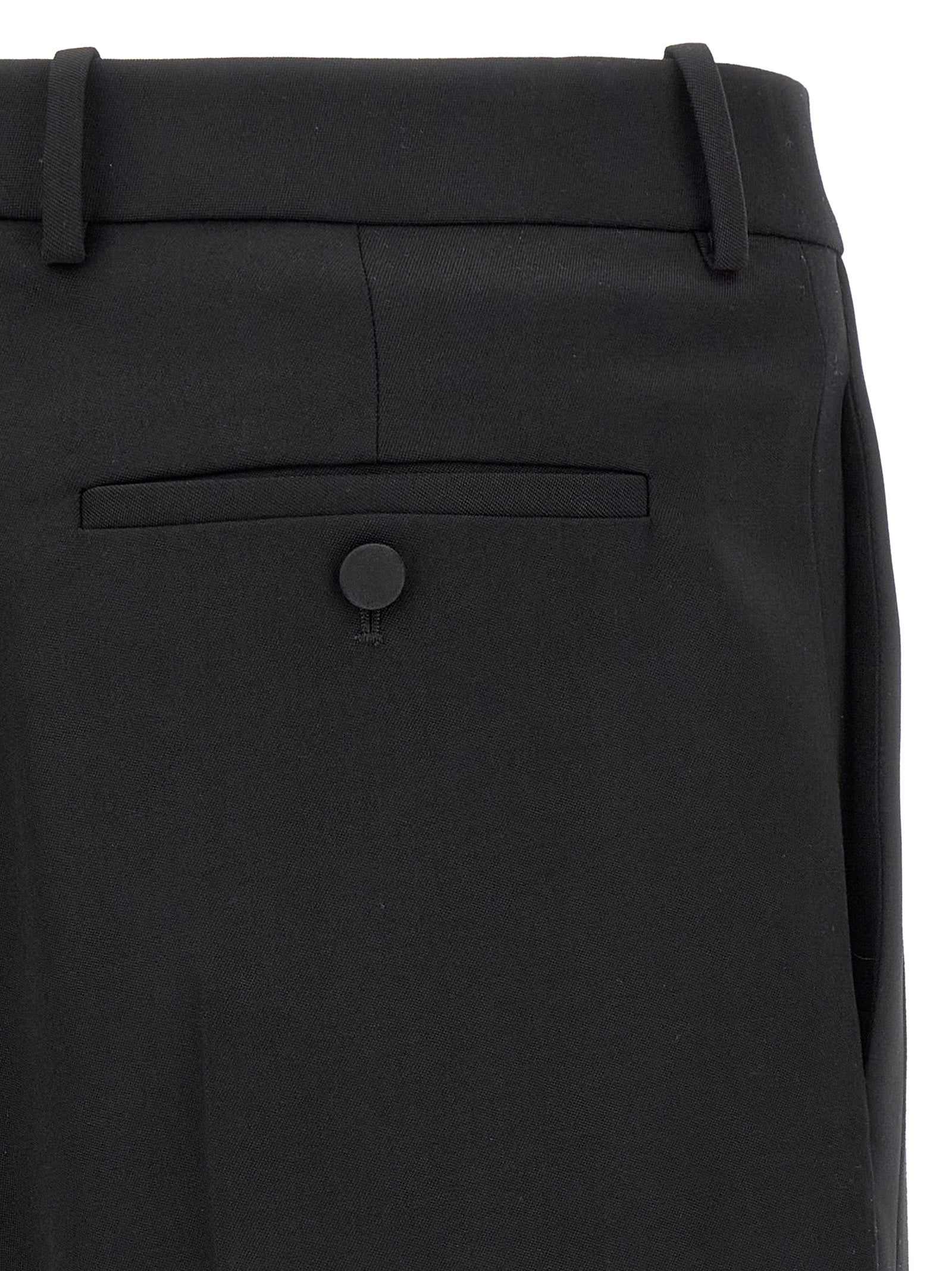 Elevate your wardrobe with Saint Laurent Black Wool Dress Pants, meticulously crafted in luxurious grain de poudre wool, embodying timeless sophistication and refined elegance.