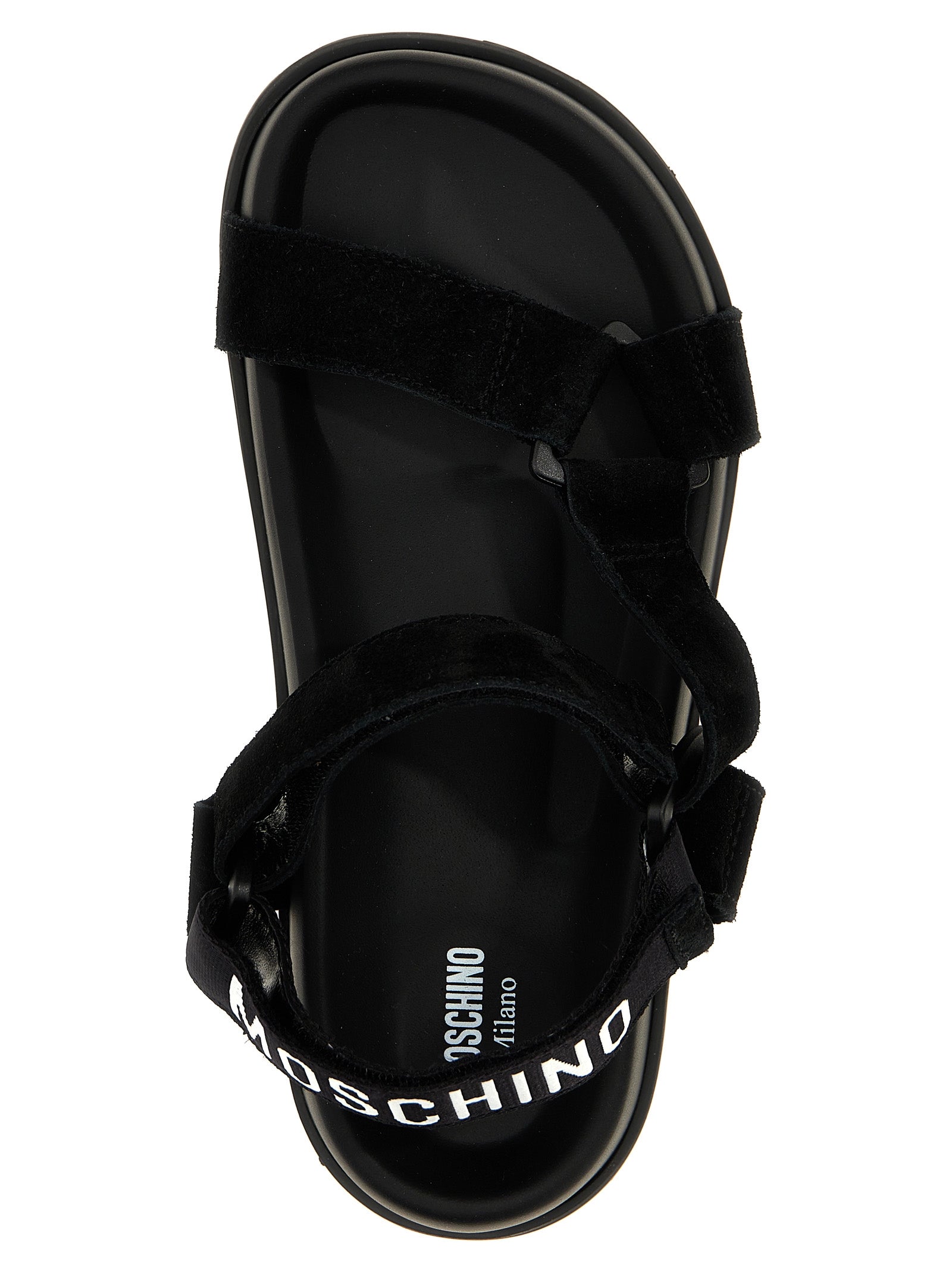 Step into a realm of sophistication with Moschino Black Calfskin Flat Sandals, where artisanal luxury meets bold design for the discerning individual.