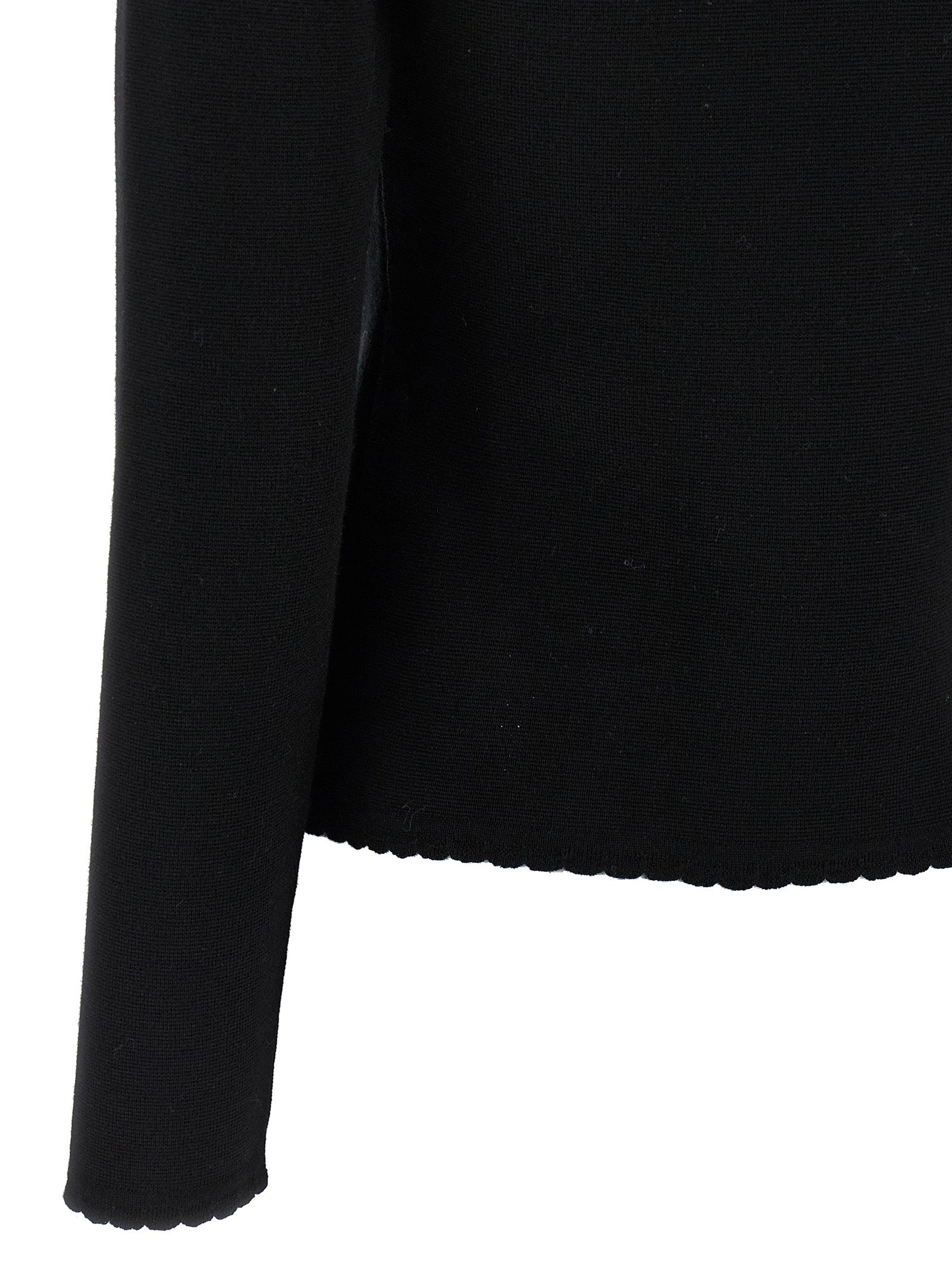 Indulge in the Moschino Black Virgin Wool Cardigan, a masterpiece of artisanal luxury, blending exquisite craftsmanship with timeless elegance for the discerning connoisseur.