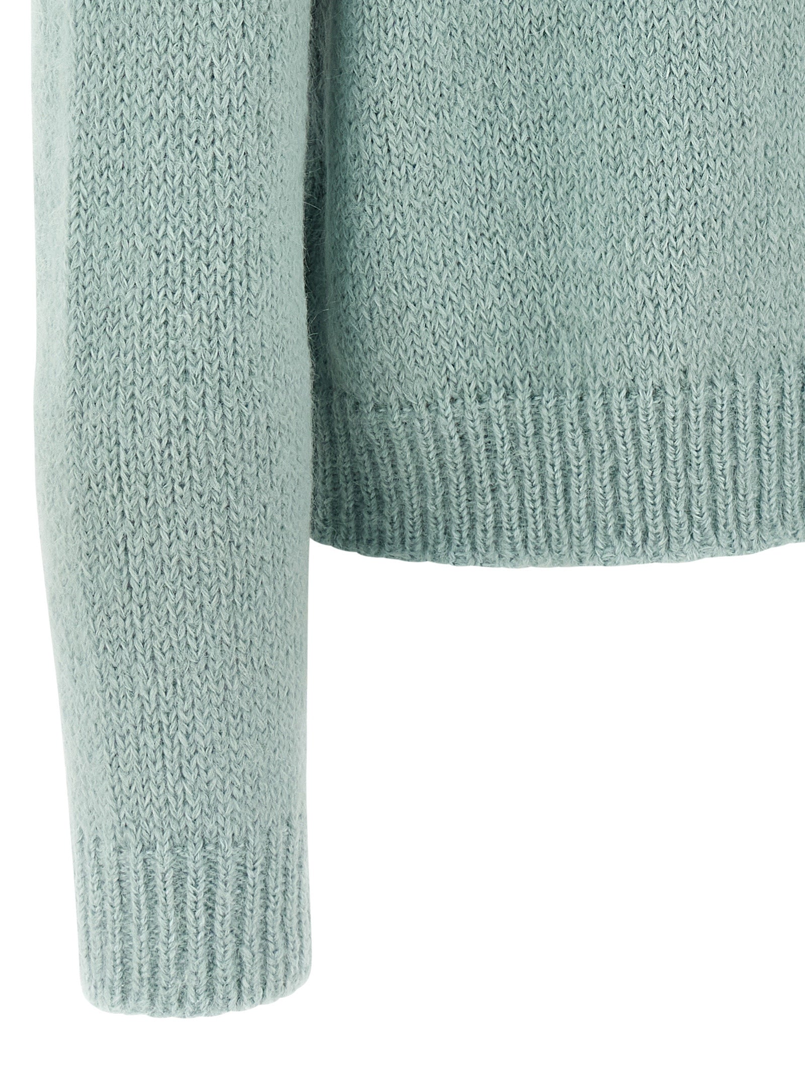 Indulge in the Jil Sander Blue Alpaca Leather Cardigan, a masterpiece of artisanal luxury crafted from premium alpaca wool, epitomizing timeless elegance and sophistication.