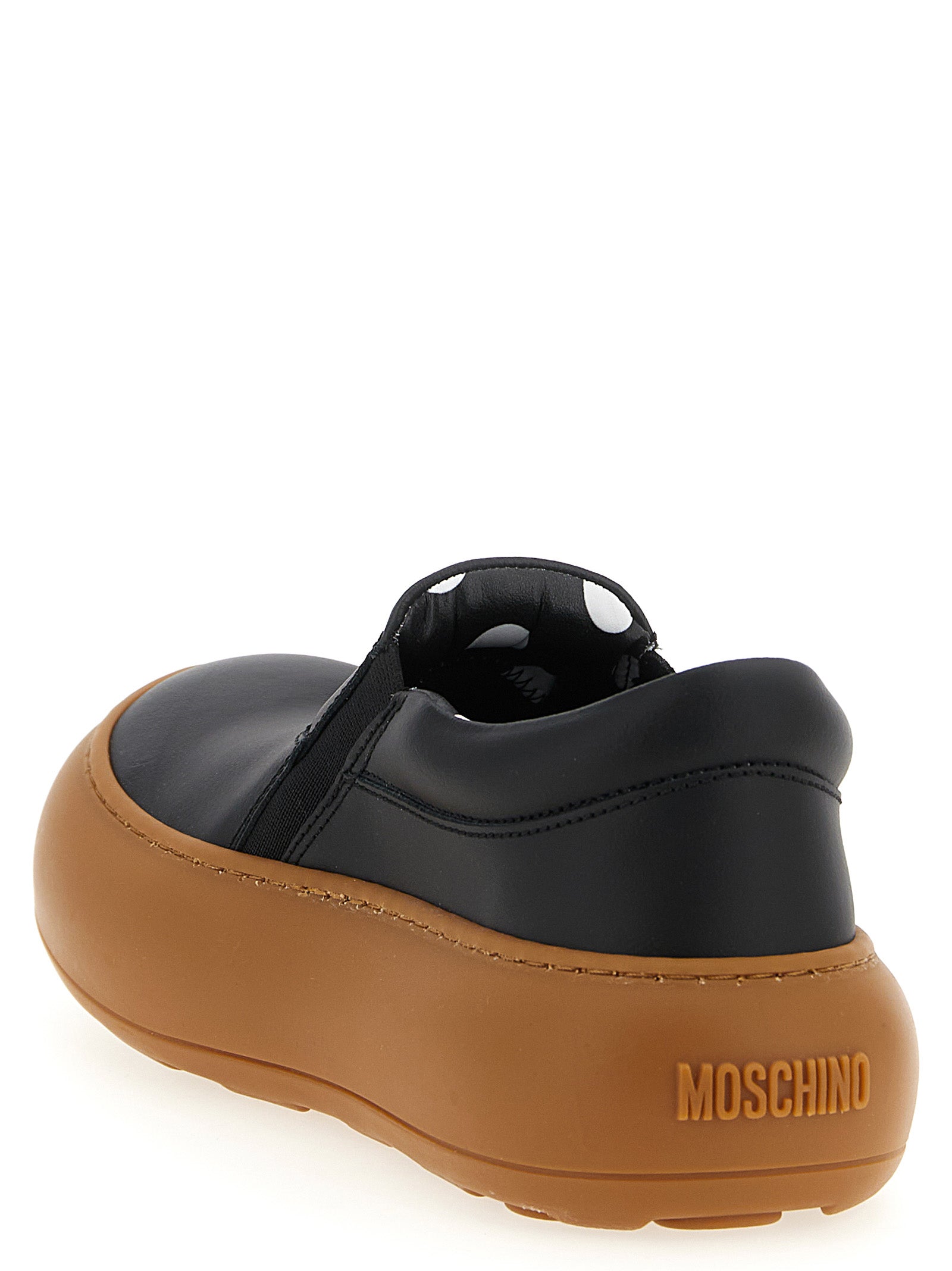 Discover Moschino's Black Leather Chunky Sneakers, where artisanal luxury meets playful elegance, perfect for those who embrace sophistication and style.