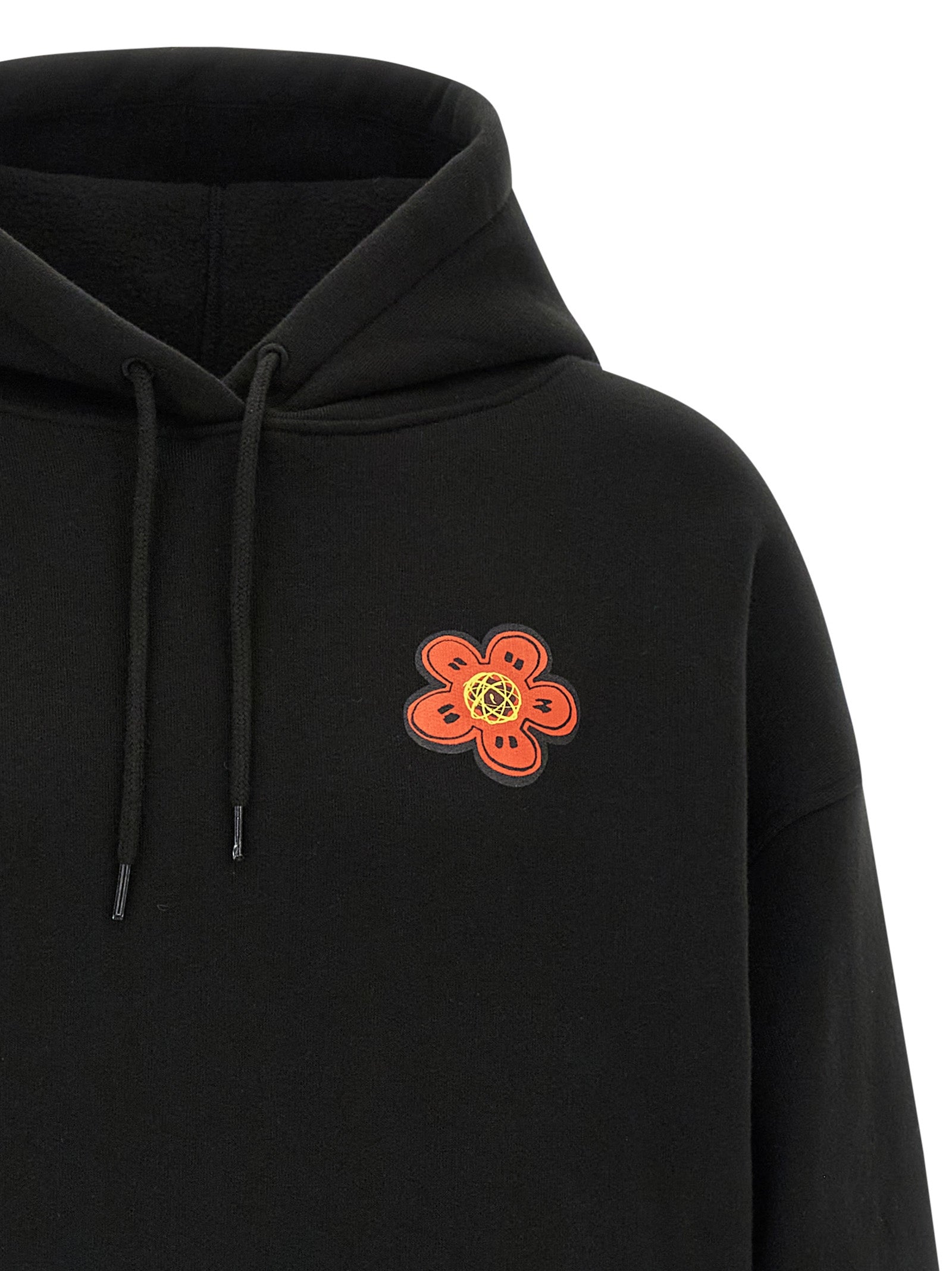 Indulge in the Kenzo Black Cotton Hoodie, a luxurious blend of artistry and comfort, crafted from 100% cotton in Portugal for the discerning individual seeking timeless elegance.