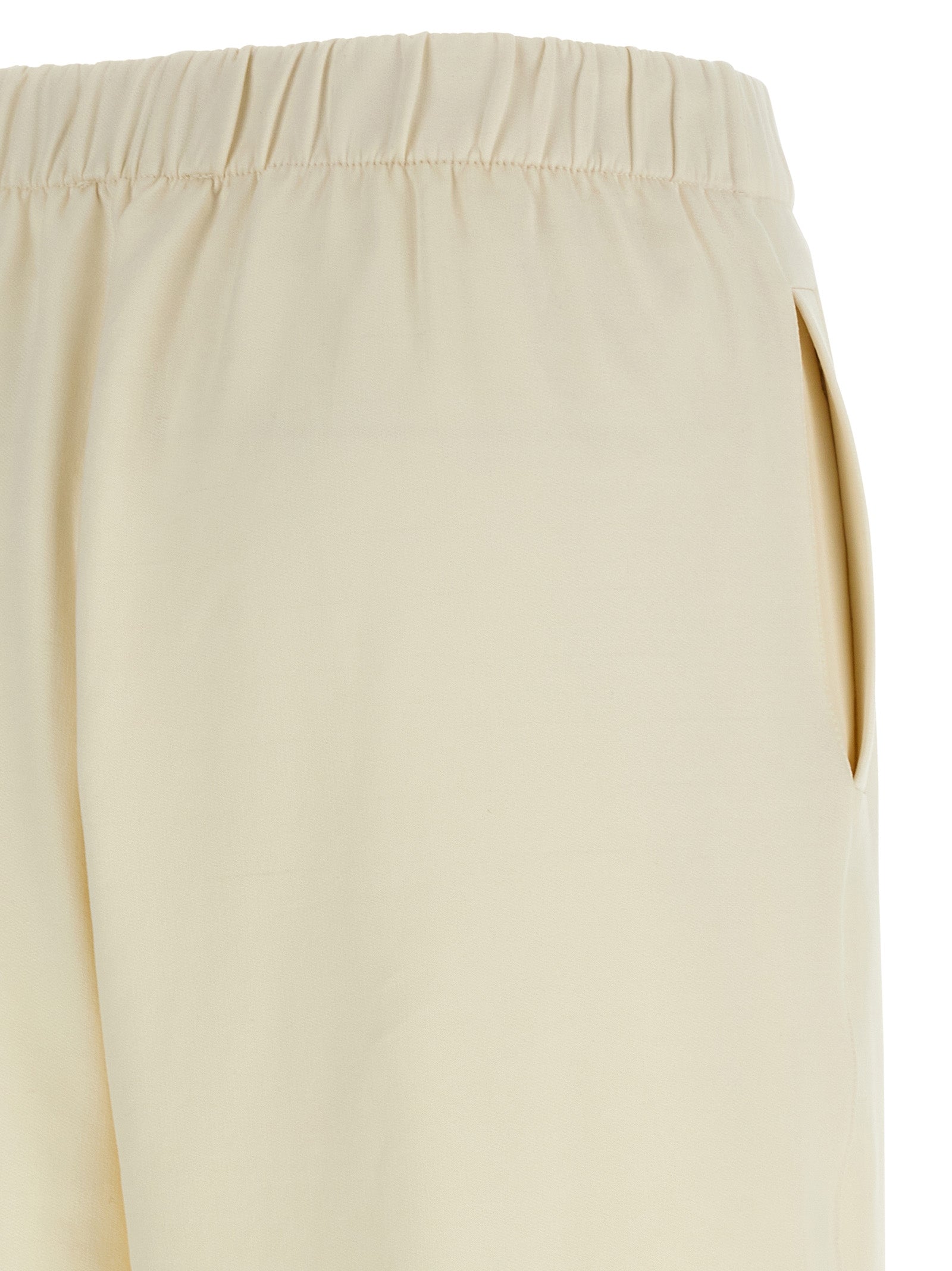 Experience the epitome of elegance with Max Mara's White Silk Casual Pants, crafted from a luxurious silk-cotton blend for timeless sophistication and effortless allure.