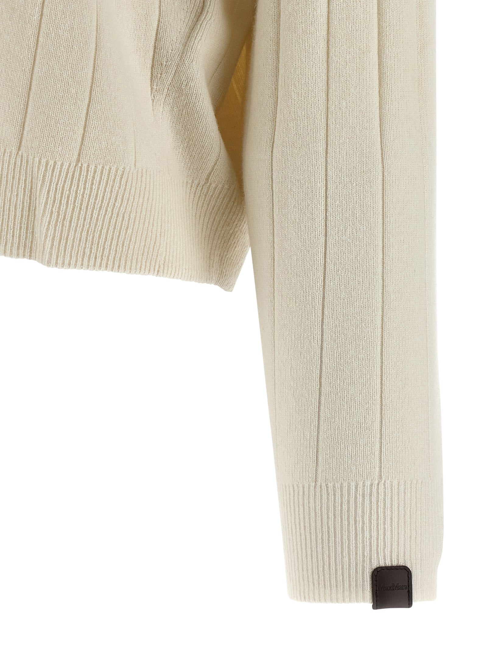 Indulge in the Max Mara White Cashmere Cardigan, a luxurious blend of elegance and comfort, perfect for the discerning fashion connoisseur seeking timeless sophistication.