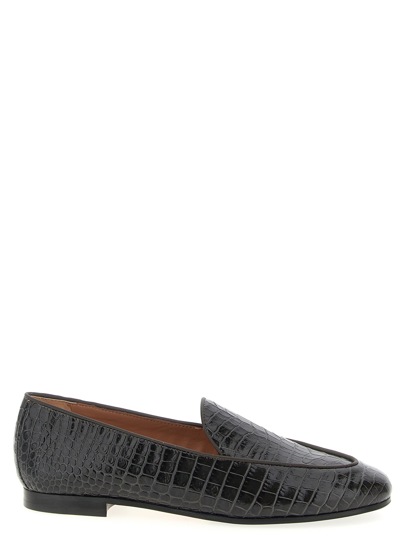 Discover Aquazzura's Black Calfskin Slip-On Loafers, where Italian craftsmanship meets timeless elegance, elevating your style with luxurious sophistication.