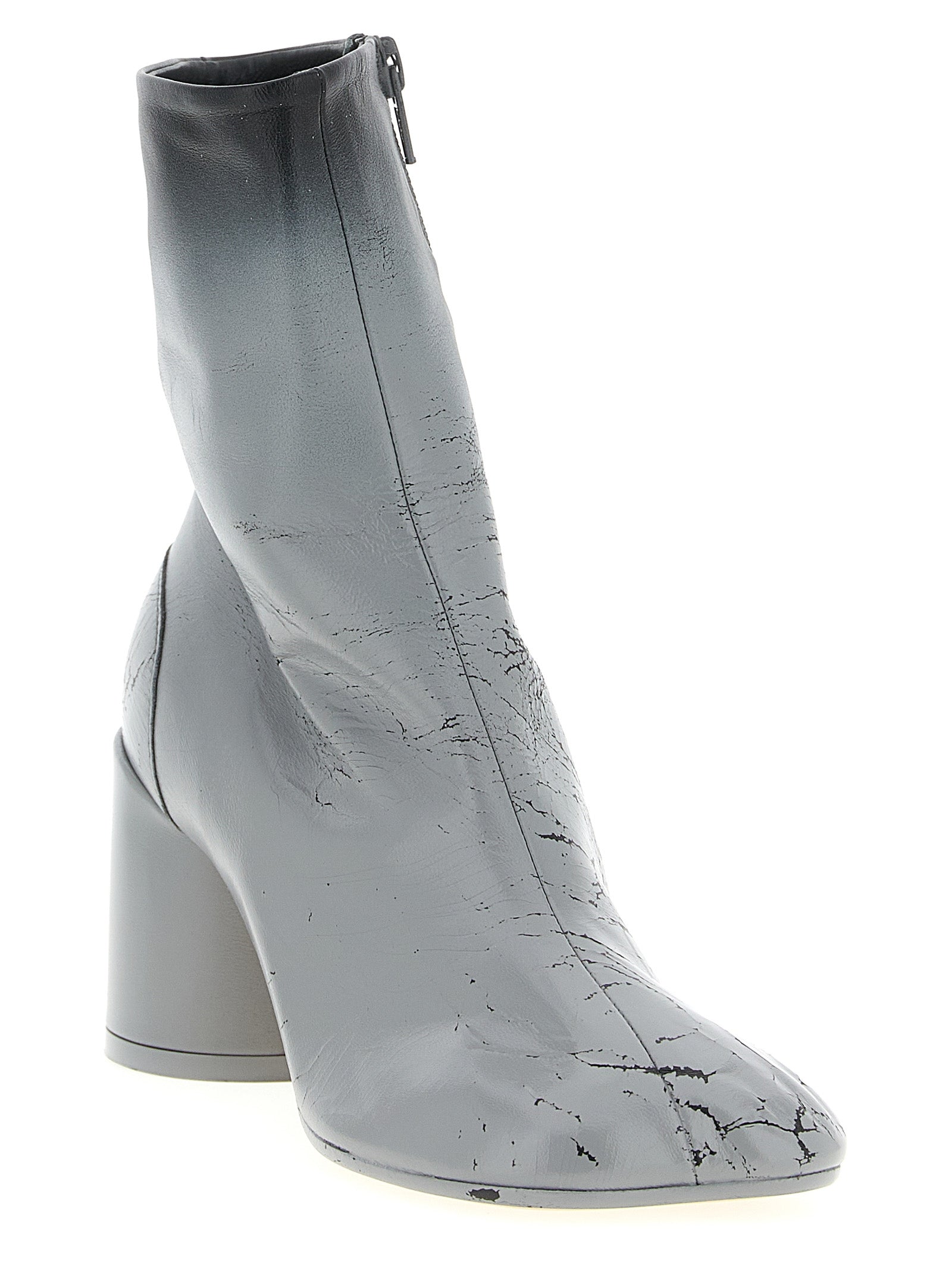 Experience the allure of MM6 Maison Margiela's Gray Lambskin Ankle Boots, where exquisite craftsmanship meets avant-garde elegance for the discerning fashion connoisseur.