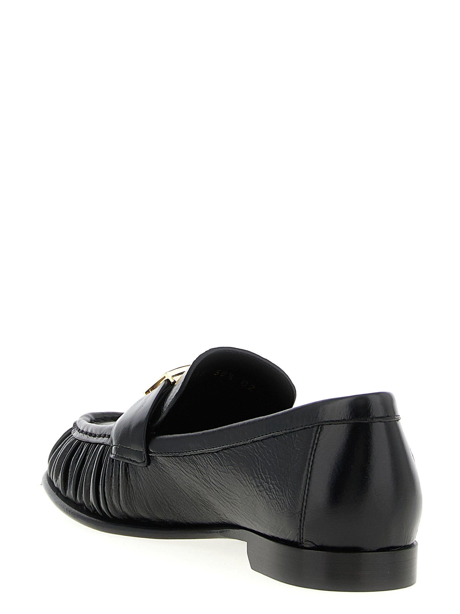 Indulge in the exquisite Fendi Black Lamb Leather Slip-On Loafers, where artisanal craftsmanship meets timeless elegance, perfect for elevating any sophisticated ensemble.