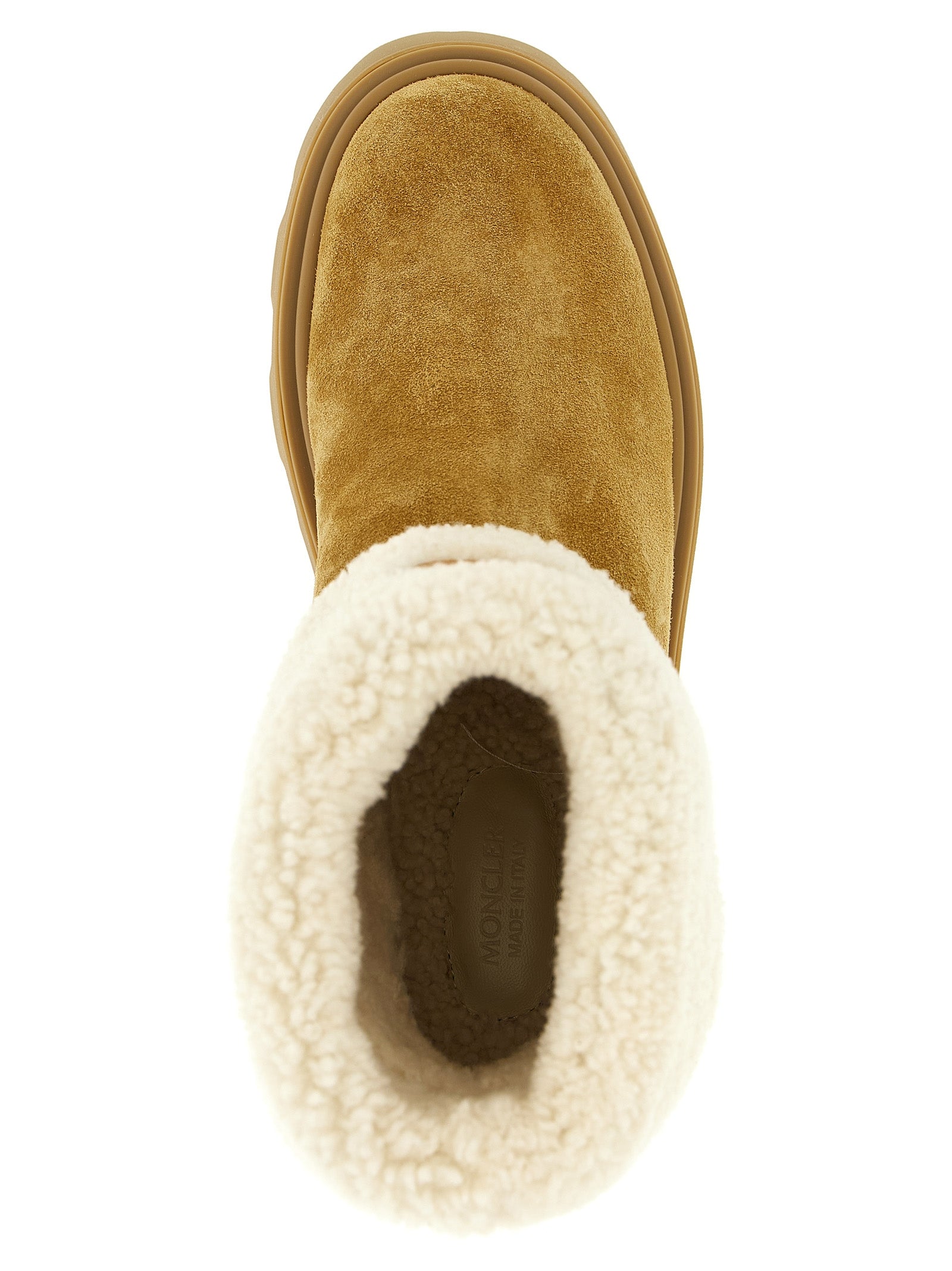 Indulge in Moncler's Aurea beige calfskin ankle boots, where luxurious shearling meets exquisite craftsmanship, elevating your style with timeless elegance.