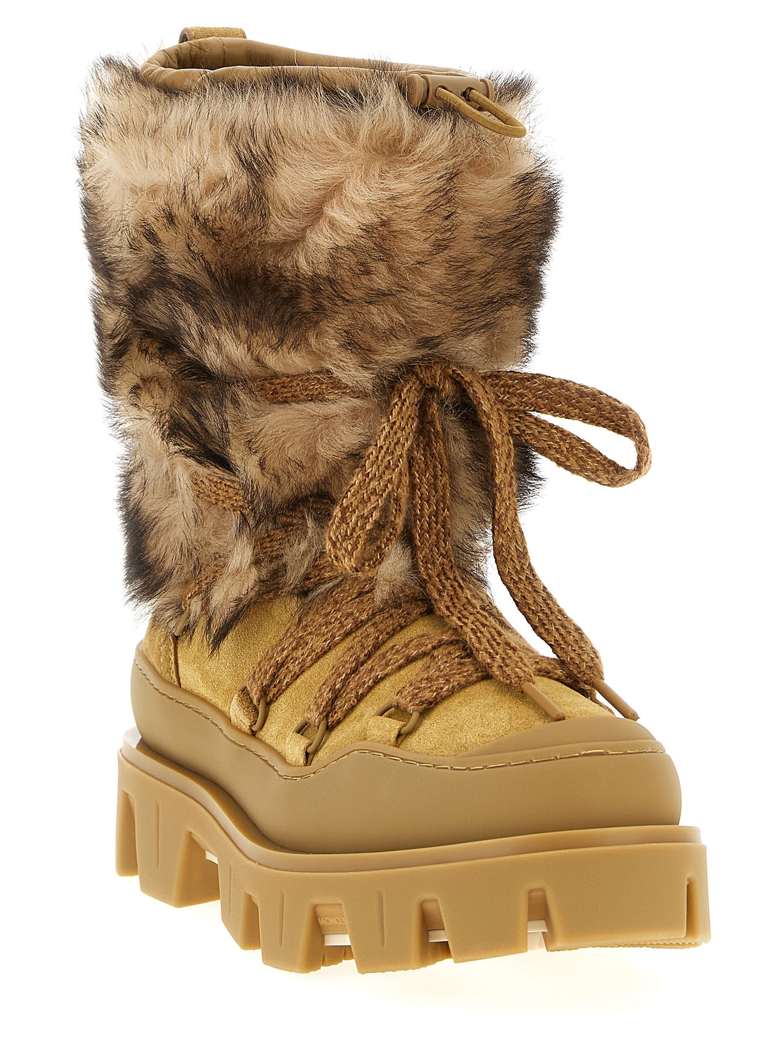 Indulge in the elegance of Moncler's Brown Calfskin Flat Boots, where luxurious shearling and exquisite craftsmanship meet sophisticated style for the discerning individual.