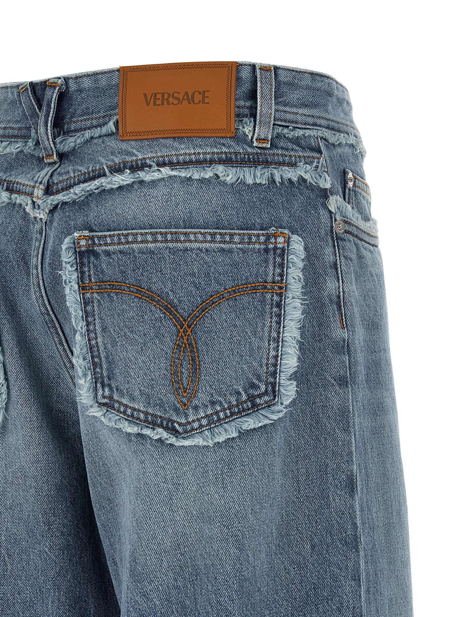 Elevate your style with Versace's Blue Cotton Boyfriend Jeans, crafted from luxurious stonewashed denim, embodying sophistication and effortless chic for every occasion.