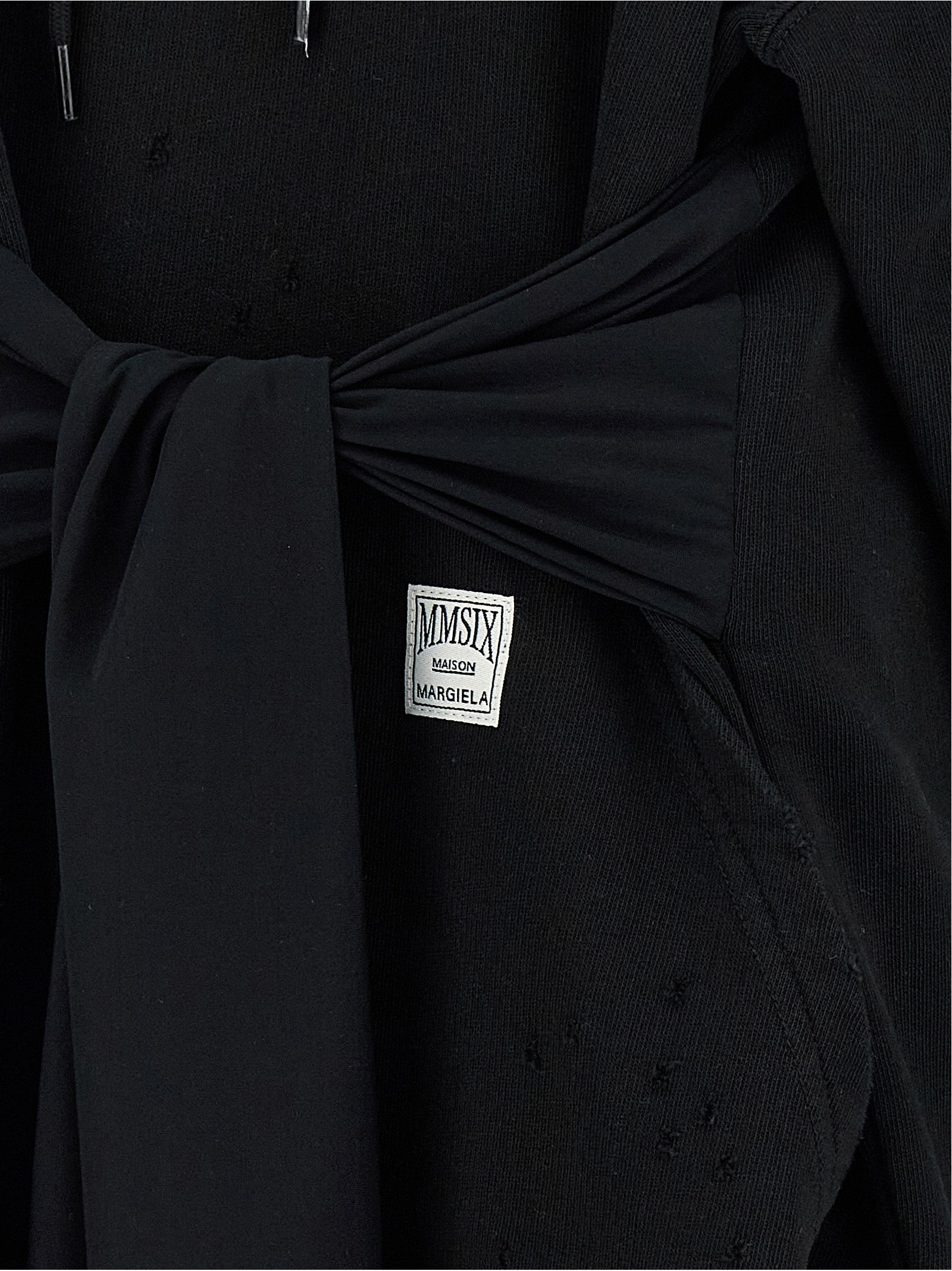 Discover the MM6 Maison Margiela Black Cotton Short Dress, an avant-garde masterpiece that merges exquisite craftsmanship with bold elegance, perfect for the discerning individual.