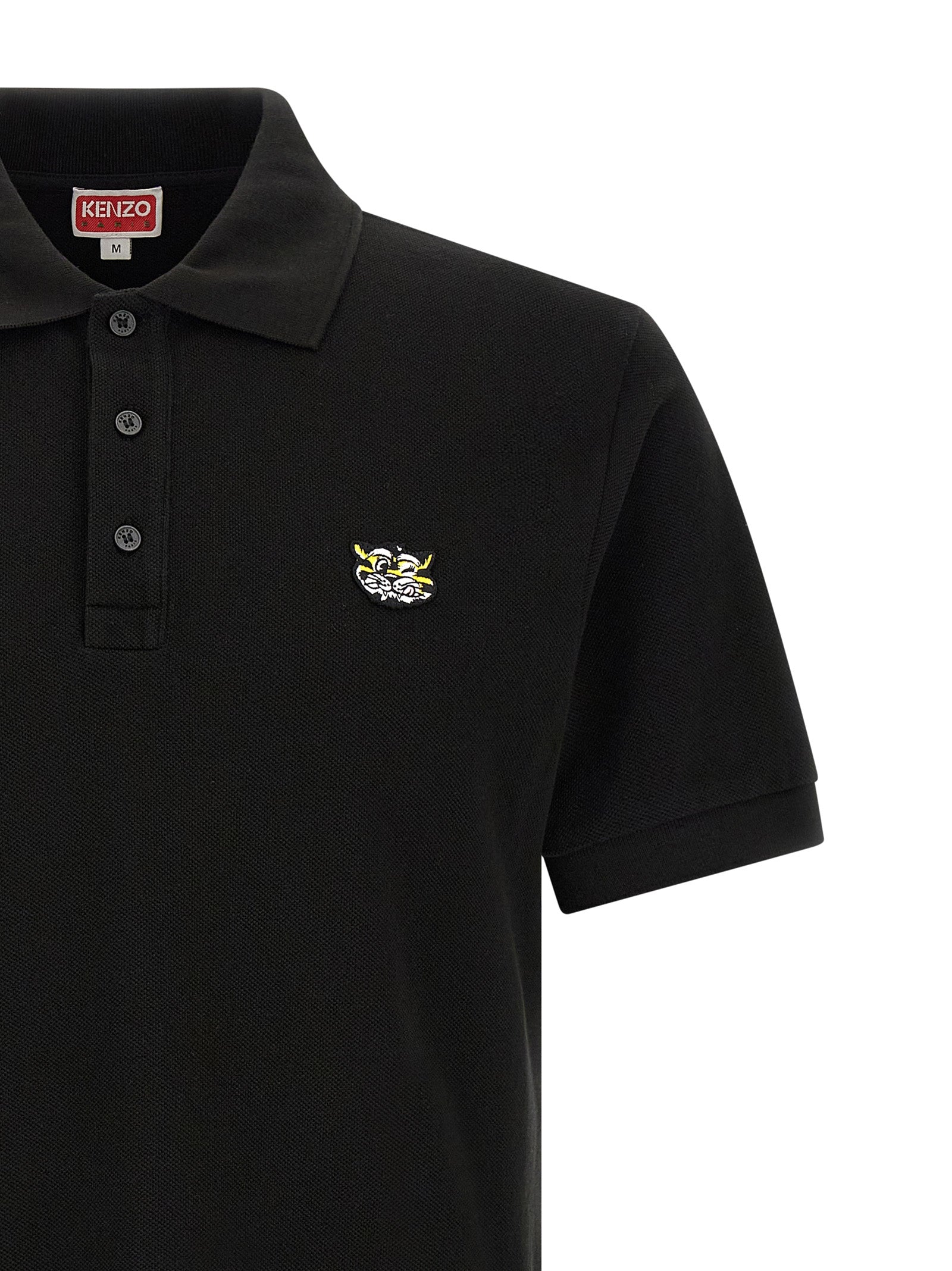 Discover the KENZO Black Cotton Piqué Polo Shirt, a blend of luxury and bold style, featuring exquisite craftsmanship and a striking Wild Tiger patch for the discerning individual.