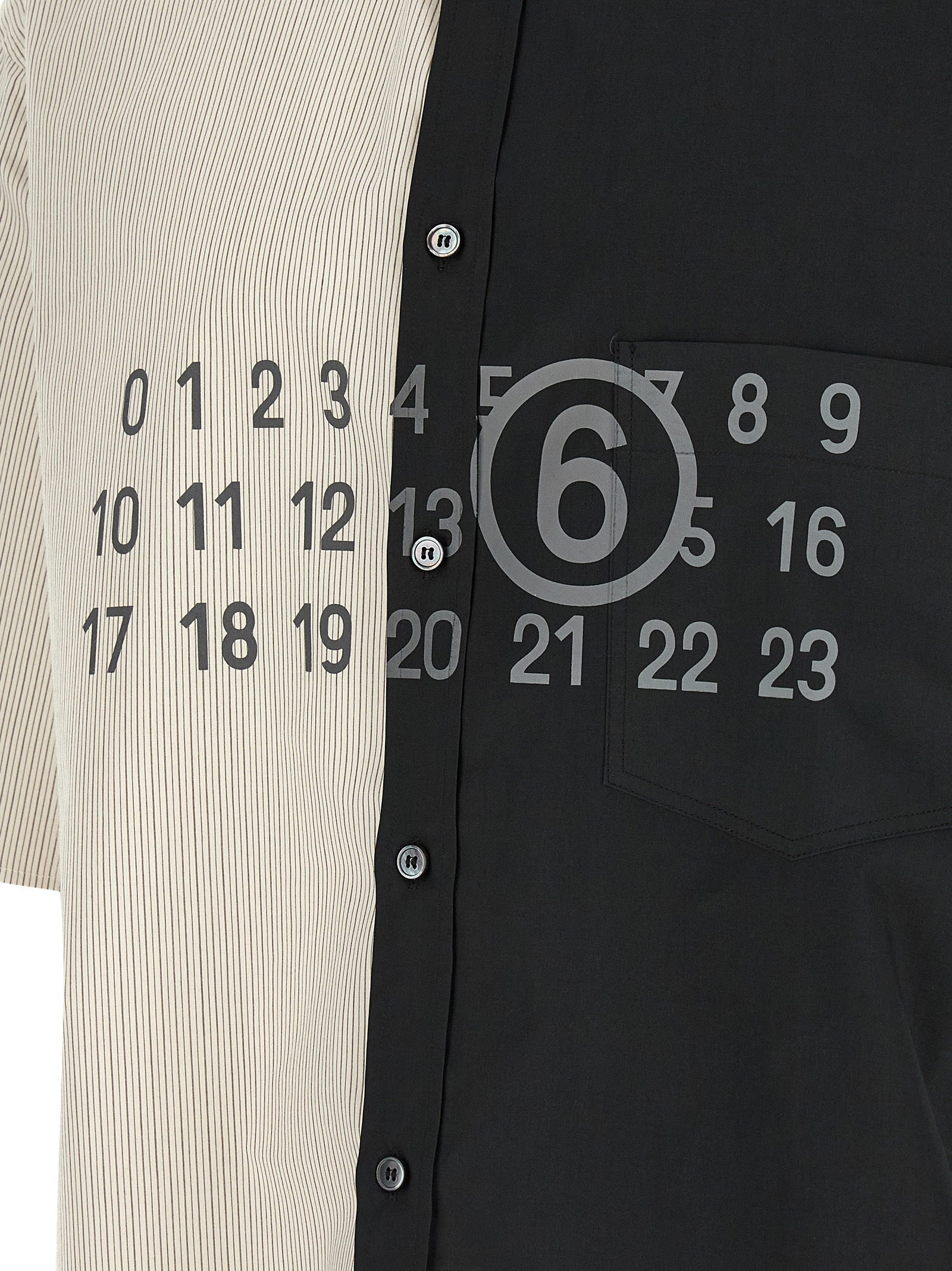 Elevate your wardrobe with the MM6 Maison Margiela Black Cotton Blouse, showcasing exquisite patchwork design and luxurious craftsmanship for the discerning individual.